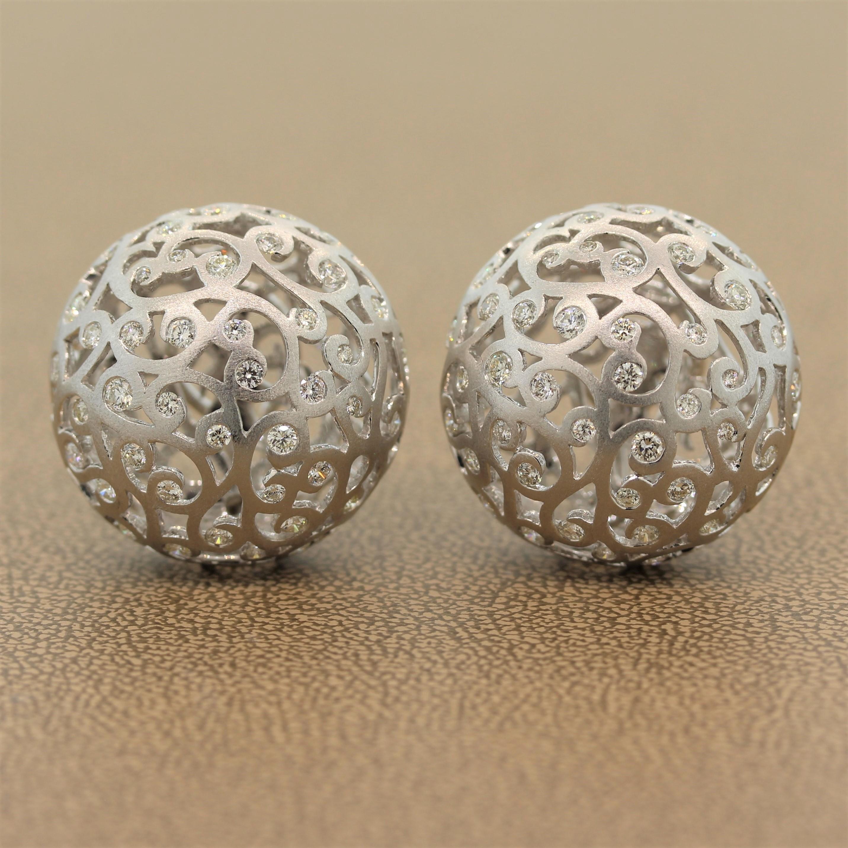 A fun and elegant pair of earrings featuring 2.32 carats of VS quality diamonds hugged by the filigree design of each 18K white gold sphere. The brushed finished domes are lightweight with an omega clip backing.   

Earring Circumference: 0.80