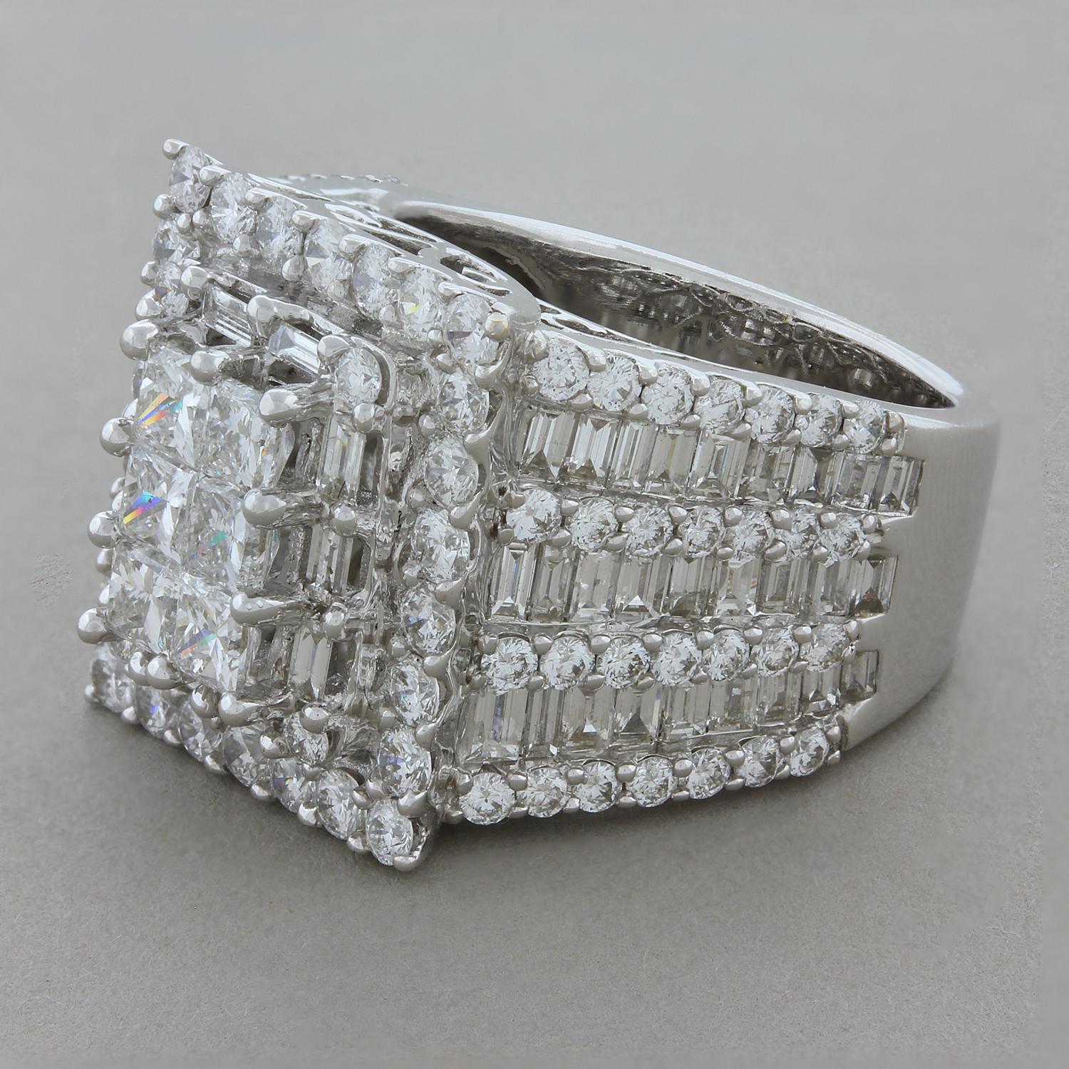 A magnificent three-sided ring featuring 6.30 carats of diamonds. The flat top has a bed of princess cut diamonds with a halo of baguette cut diamonds followed by a double halo of round cut diamonds. The two sides have three rows of baguette cut