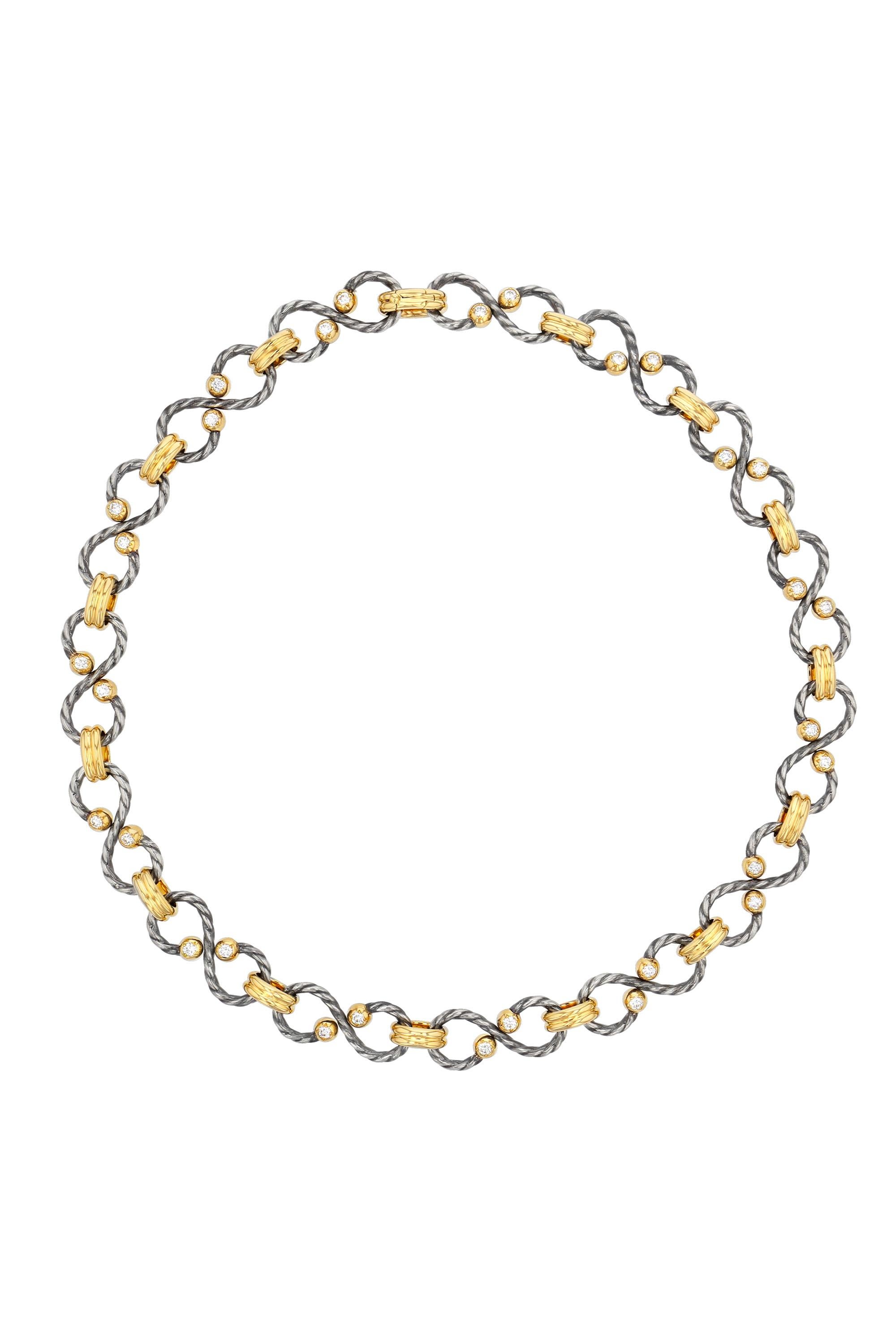 Choker chain alternating yellow gold gadrooned rings and distressed silver twisted serpentine rings punctuated with gold balls set with a diamond.

Details:
GVS Diamonds: 1.2 cts
18k Yellow Gold : 35 g
925 Distressed Silver : 20 g
Made in France
