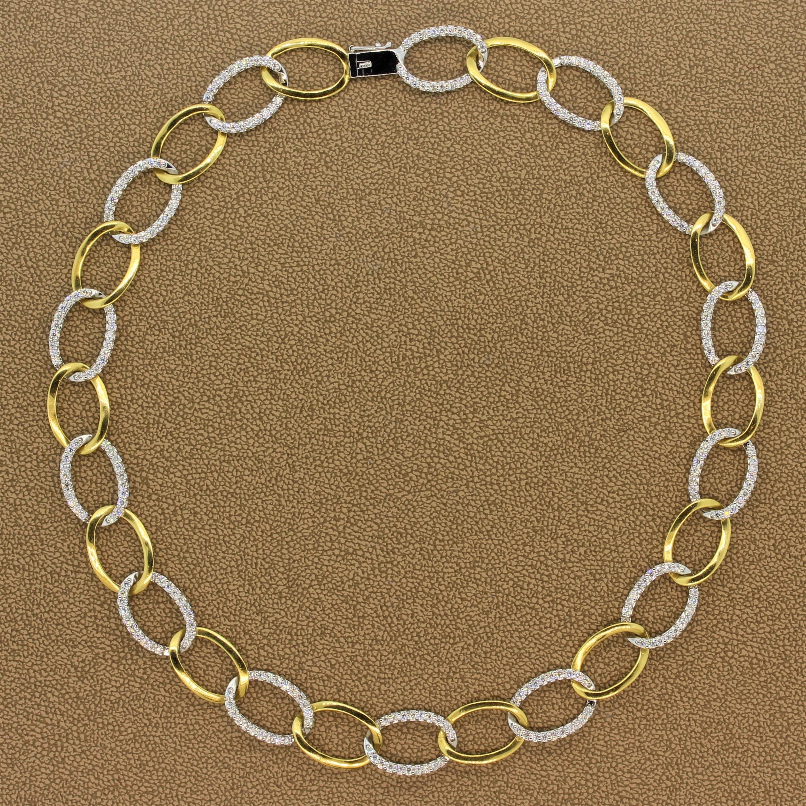 A beautiful and fun necklace featuring 4.88 carats of VS quality diamonds. The round cut diamonds are set in 18K white gold with alternating 18K yellow gold oval shape hoops linked to one another. A box clasp and safety latch ensure for a secure