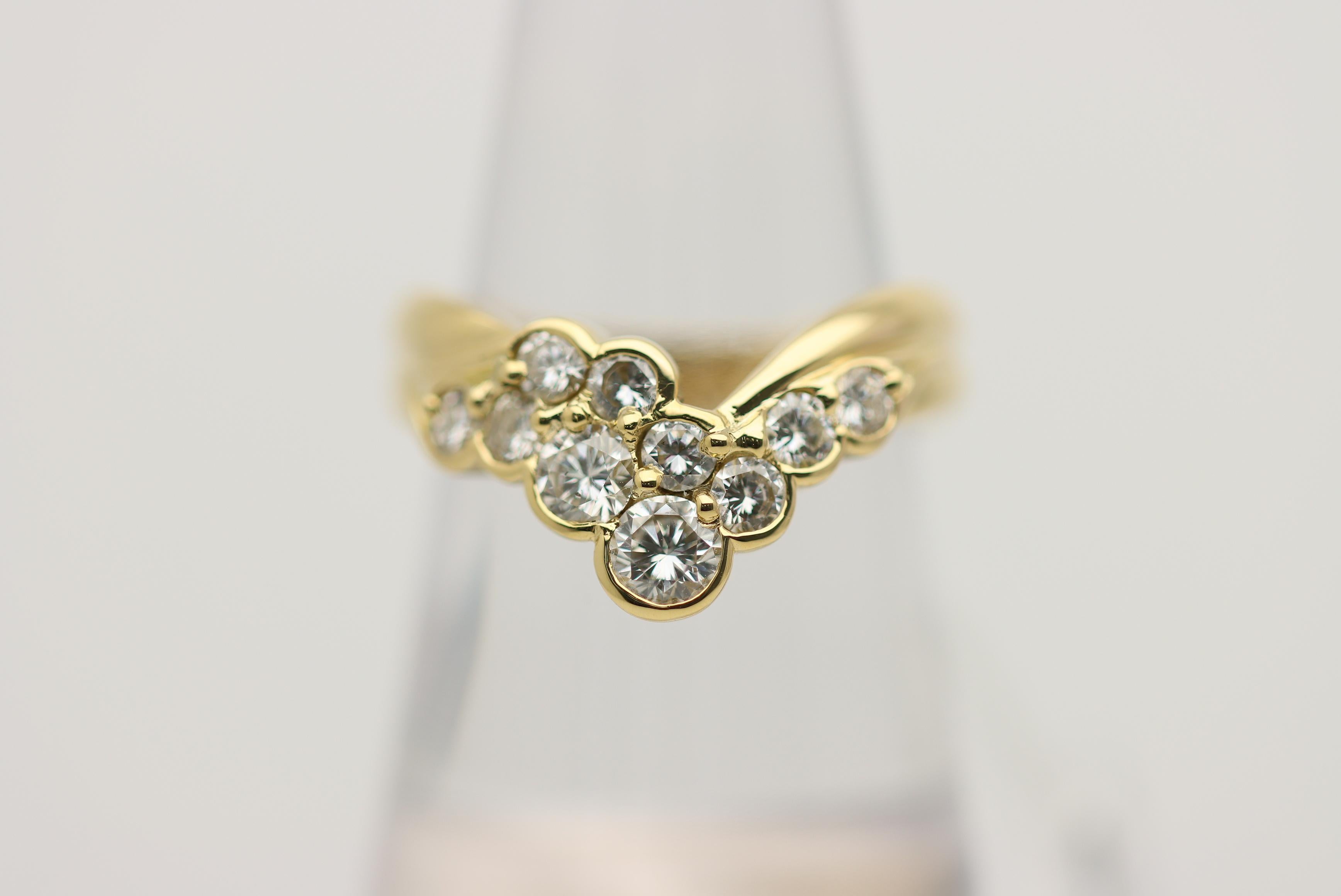 A classic V-shape diamond band with a unique and modern twist! It features 1.00 carat of larger round brilliant-cut diamonds which are both bezel and prong set in overlapping rows. Made in 18k yellow gold and ready to be worn.

Ring Size