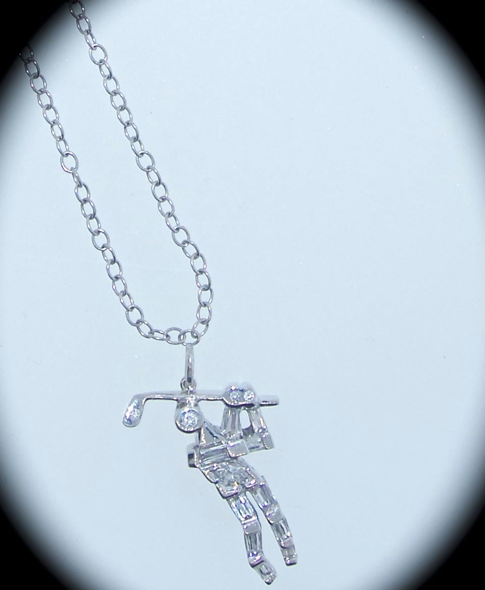 Diamond golfer pendant in 18K white gold with fancy cut fine white diamonds suspended on a white gold chain of 17 inches long.  The golfer, including the bale, is just shy of one inch long.