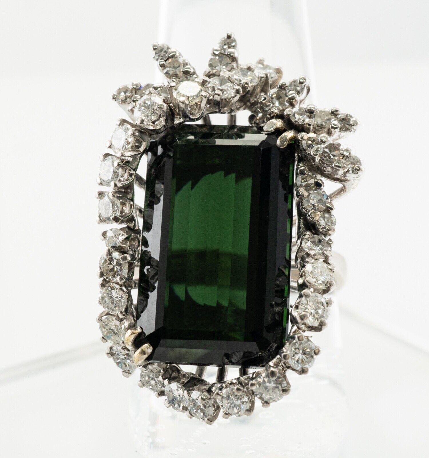 This gorgeous vintage ring is finely crafted in solid 14K White Gold (carefully tested and guaranteed) and set with natural Earth mined Tourmaline and genuine diamonds. The center emerald cut green tourmaline measures 19mm x 12mm (12.53cts). This