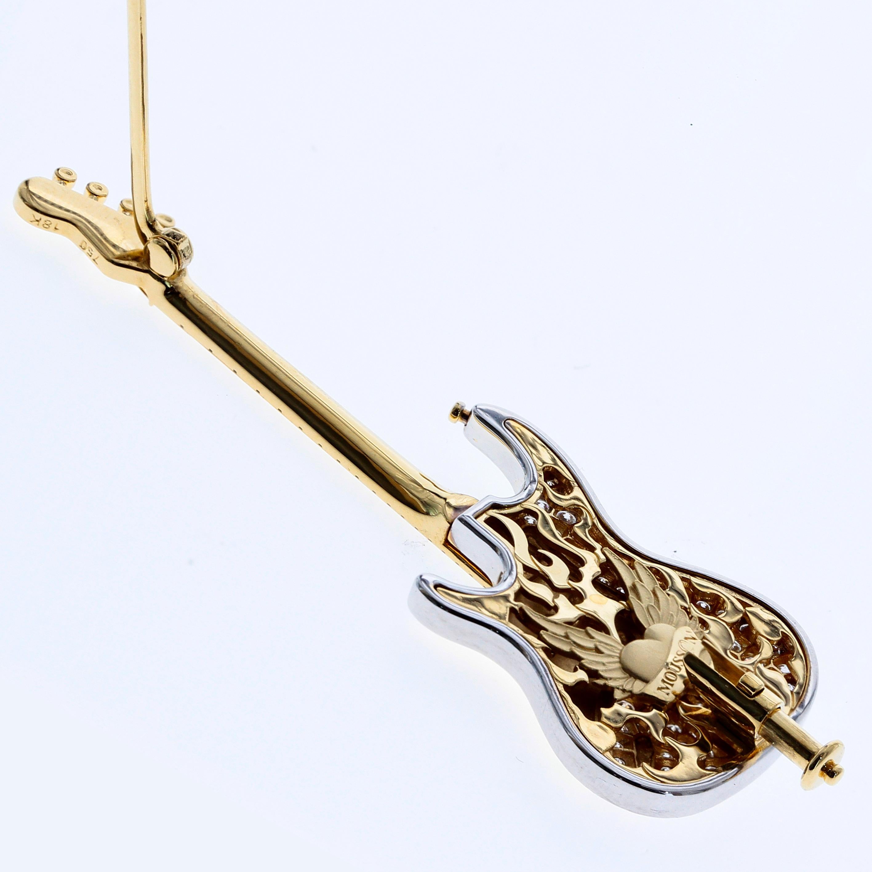 Mousson Atelier represent with prouds!
18 Karat Gold Guitar Brooch. Body with Diamonds, all gold strings are highly detailed and carefully tighten by our craftsmen. On the back side You can find rock-n-roll heart in flames.

59mm x 19mm x