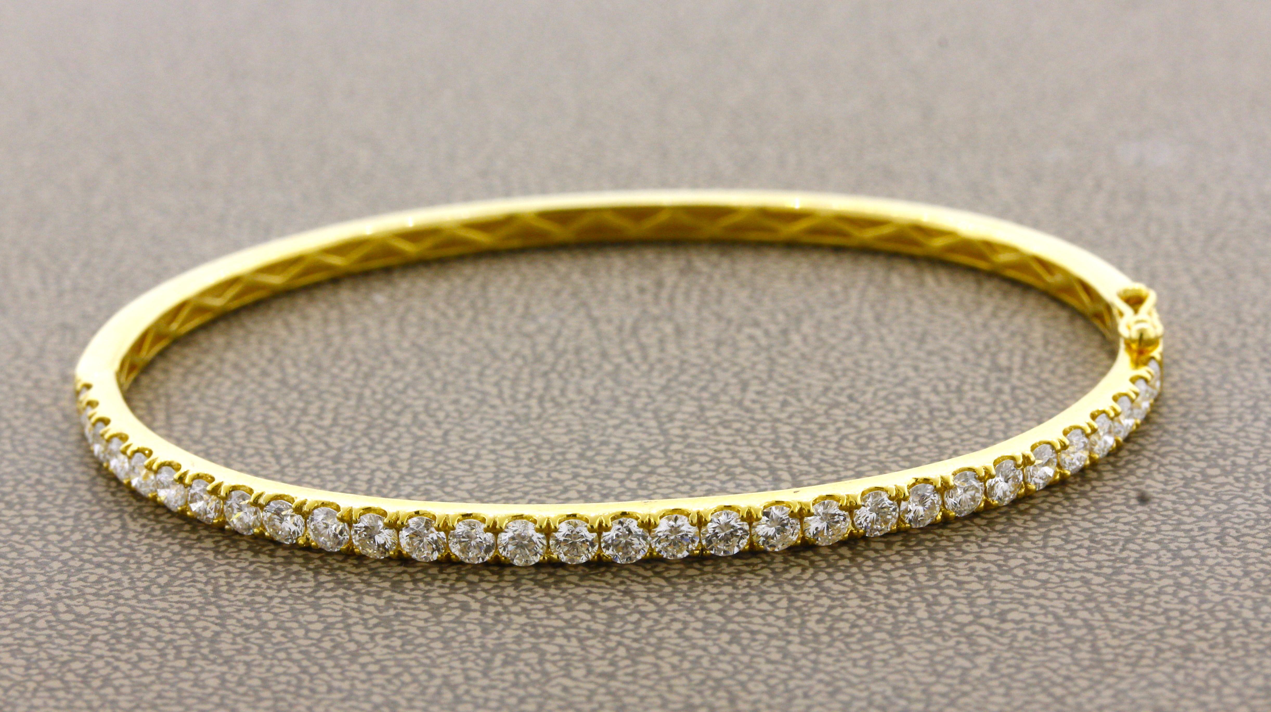 A classic and stylish bangle bracelet that can be worn daily! It features 2.50 carats of fine bright white round brilliant-cut diamonds set around half the bracelet. Made in 18k yellow gold and ready to be worn.

Circumference: 7.5 inches

Weight: