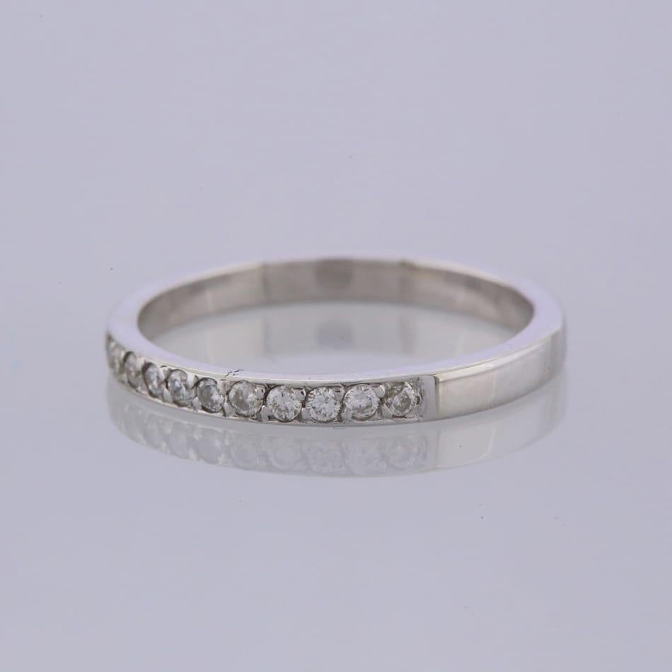 This is a 18ct white gold wedding band ring, set with 21 round brilliant cut diamonds that stretch across half of the band.

Condition: Used (Excellent)
Weight: 2.0 grams
Size: L
Band Width: 2mm
Total Diamond Carat Weight: Approx. 0.15