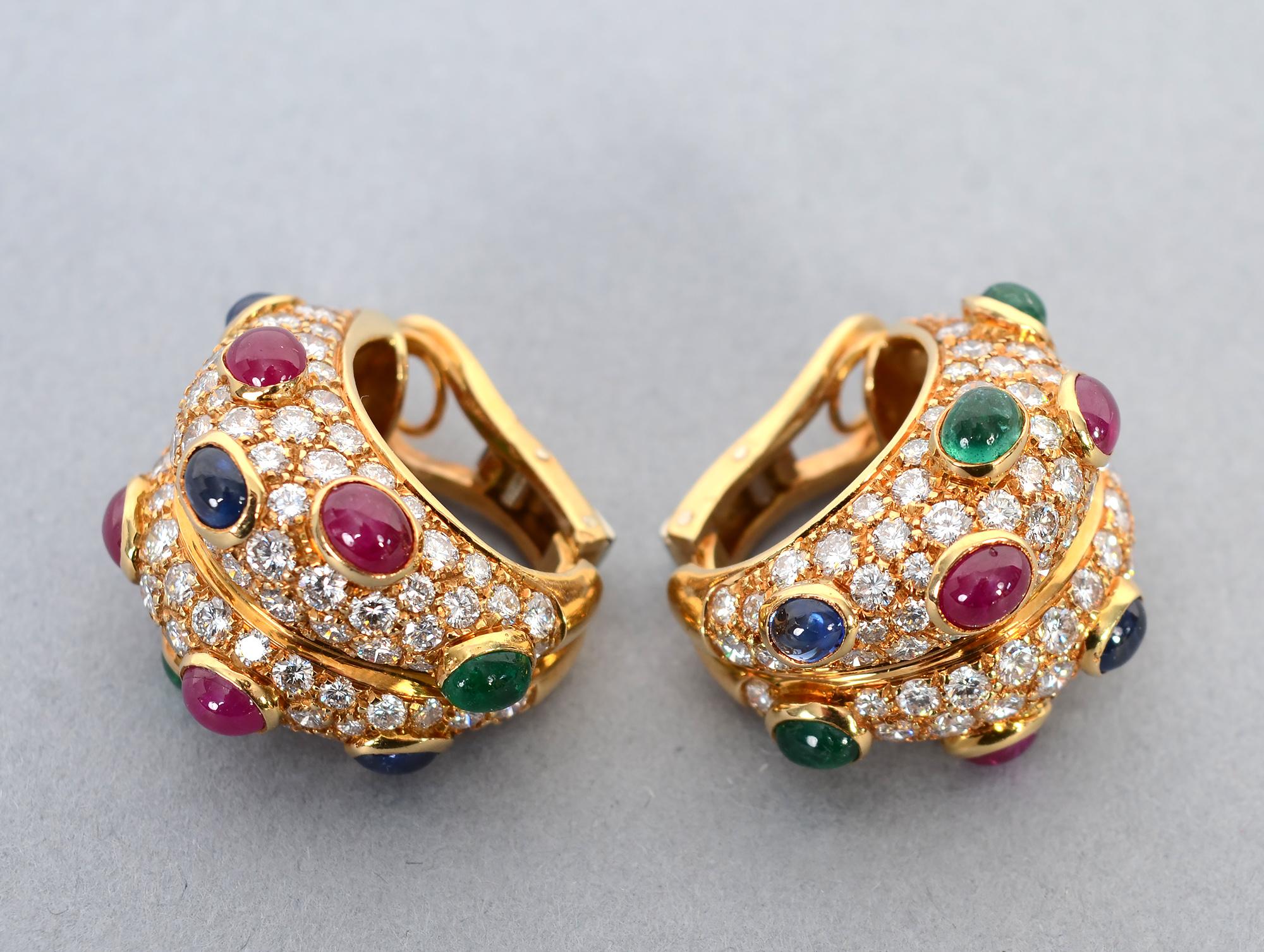 Elegant and exciting half hoop 18 karat gold earrings that have 9 carats of diamonds. The stones are F-G color; VVS - VS quality. In addition, they are studded with cabochon rubies, emeralds and sapphires. The earrings measure 5/8