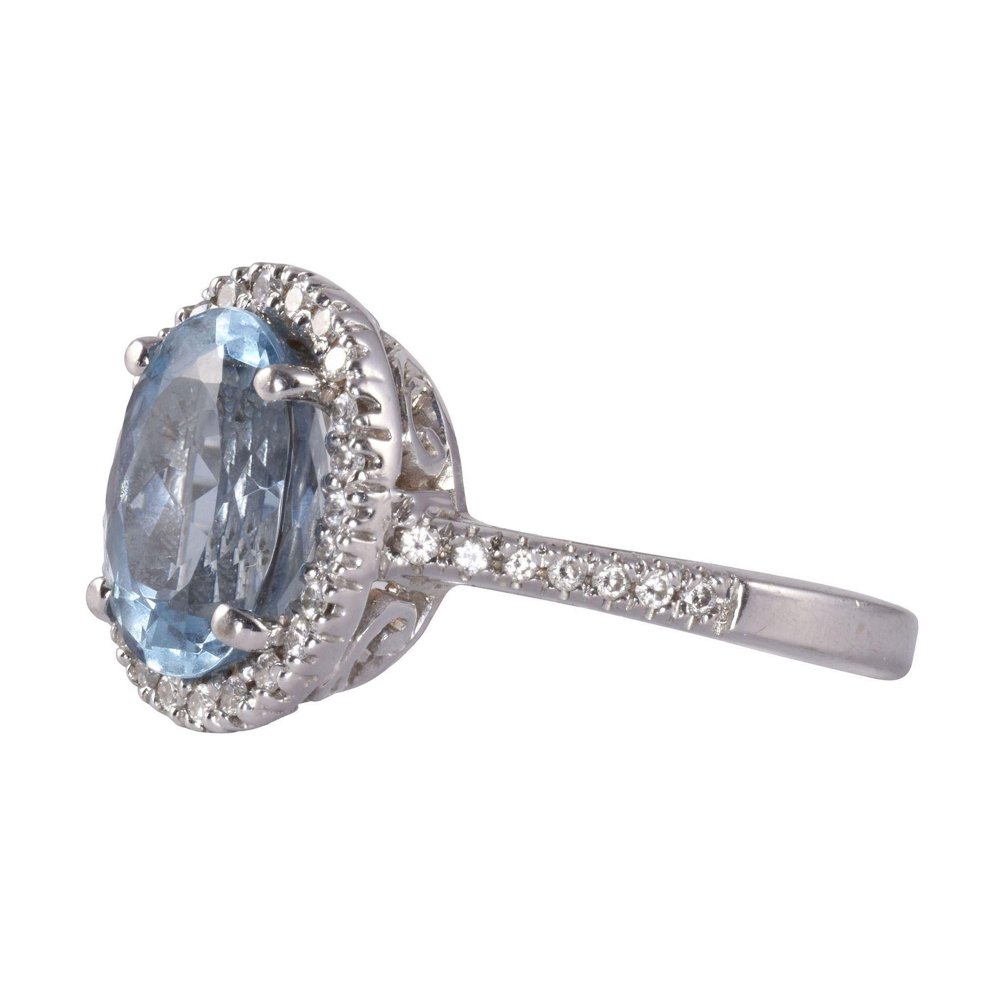 Estate diamond halo aquamarine ring. This 14 karat white gold ring features a 2.75 carat oval aquamarine center with very nice quality. It is accented with .48 carat total weight of diamonds having VS-SI clarity and G-H color. The white gold