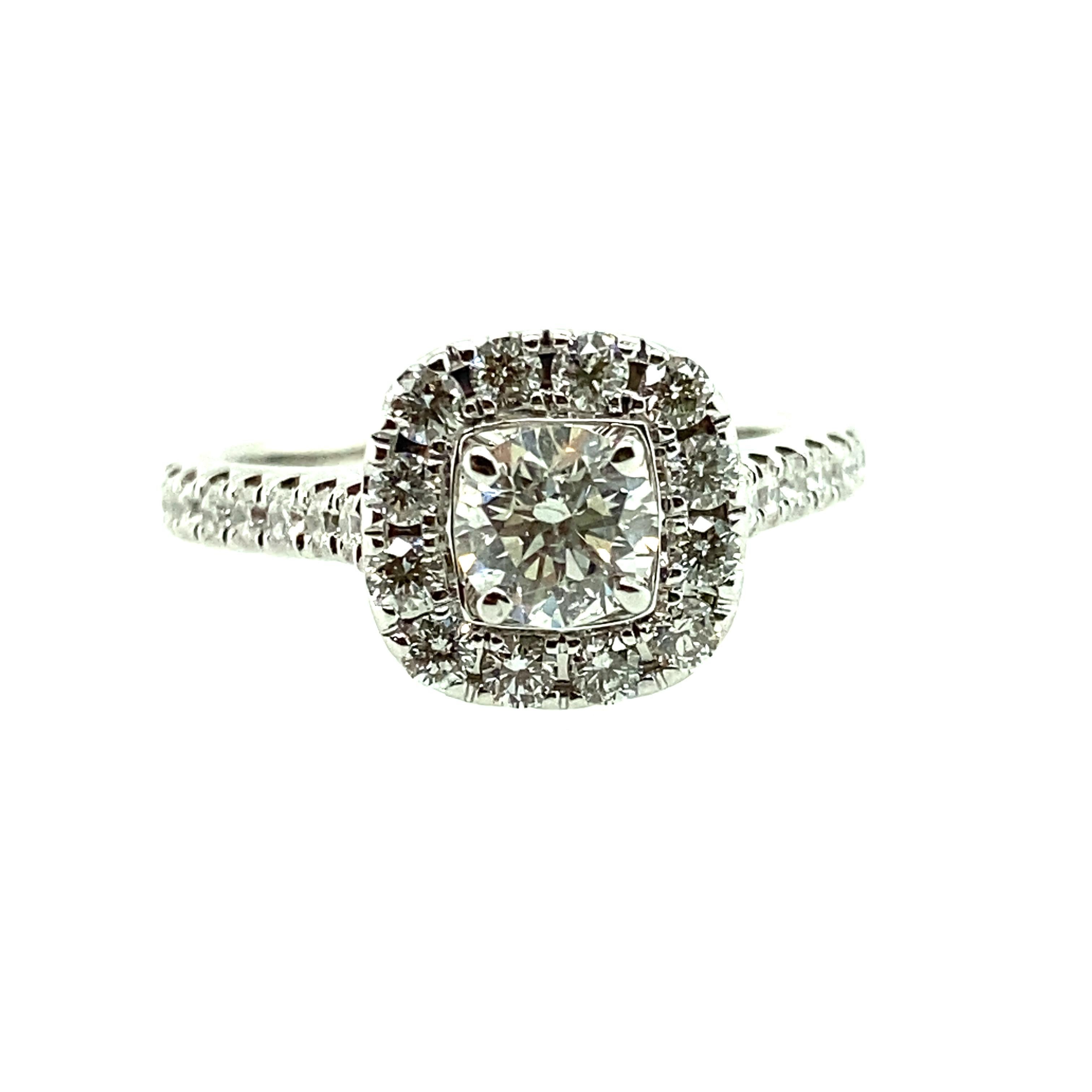 One 14 karat white gold (stamped 14K Neil Lane) diamond engagement ring set with one center modern brilliant cut diamond, approximately 0.45 carat total with H/I color and SI2 clarity surrounded by a halo of brilliant-cut diamonds, approximately