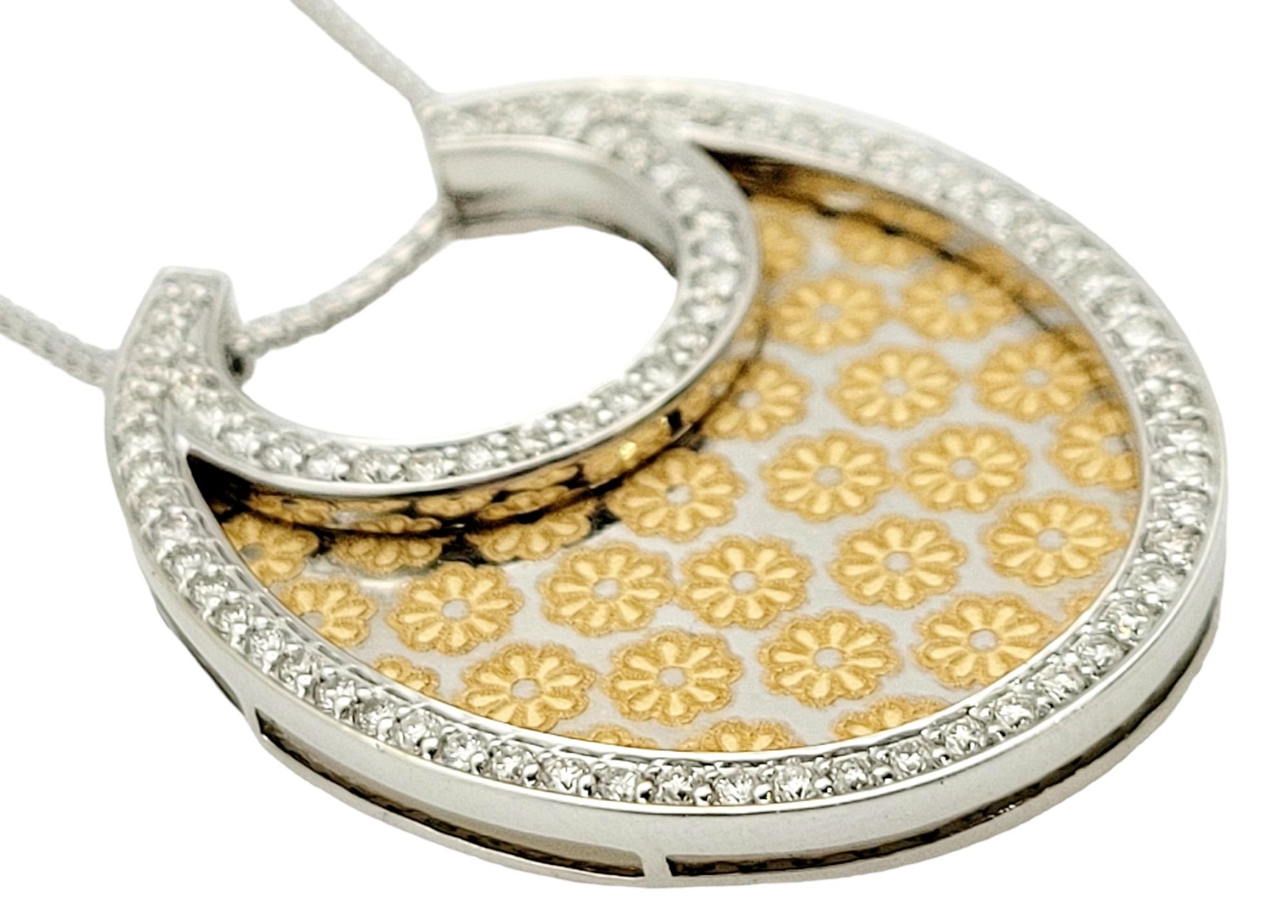 Incredibly stunning gold floral etched necklace. This beautiful necklace features a halo of 76 diamonds around the pendant. The diamonds are round brilliant, H-J in color, and SI-1 to SI-2 in clarity. These gorgeous diamonds truly sparkle and shine