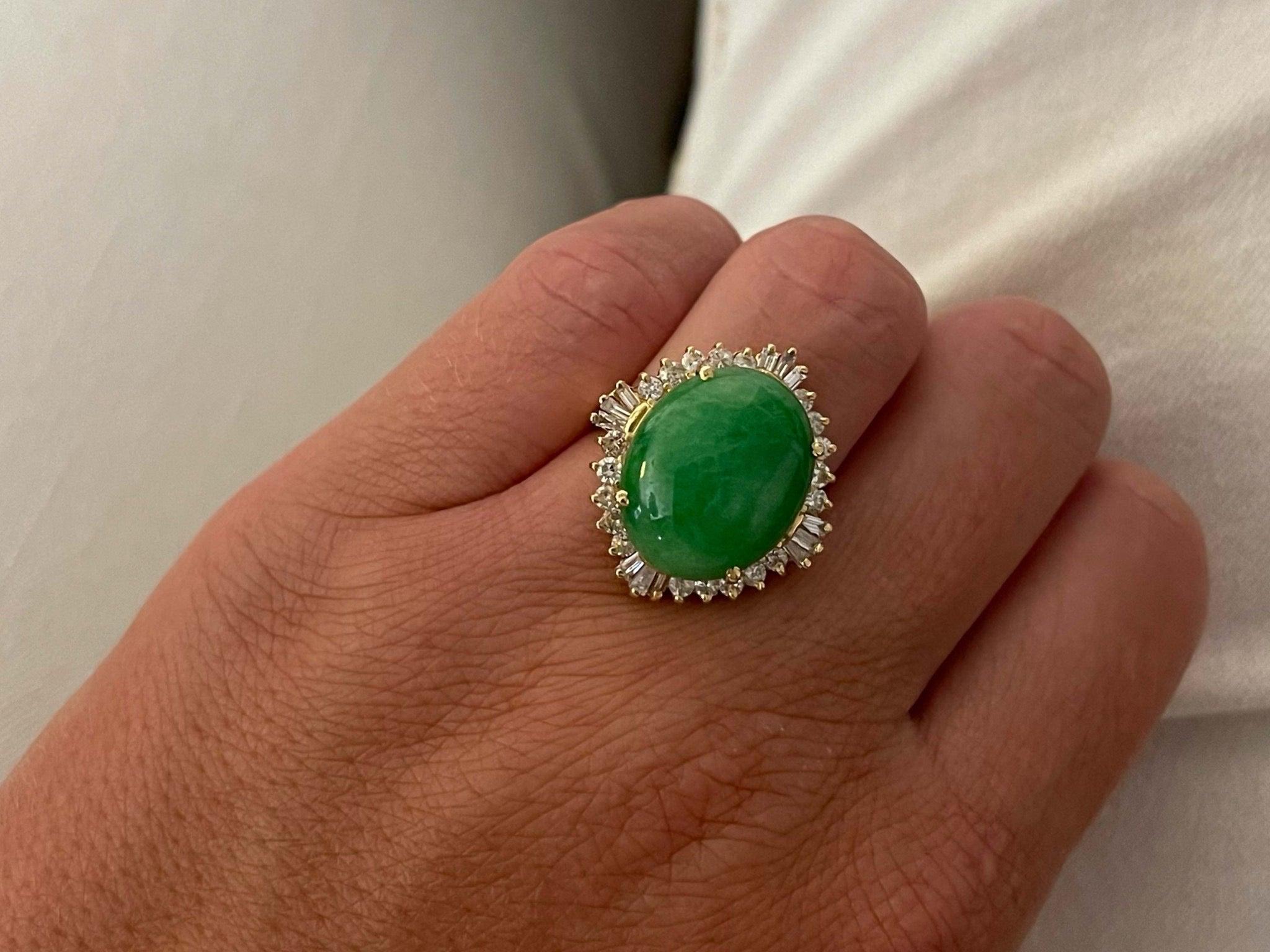 Item Specifications:

Metal: 18K Yellow Gold 

Style: Statement Ring

Ring Size: 5.5 (resizing available for a fee)

Total Weight: 8.7 Grams

Gemstone Specifications:

Center Gemstone: Jadeite Jade

Shape: Oval

Color: Green

Cut: Cabochon 

Jade