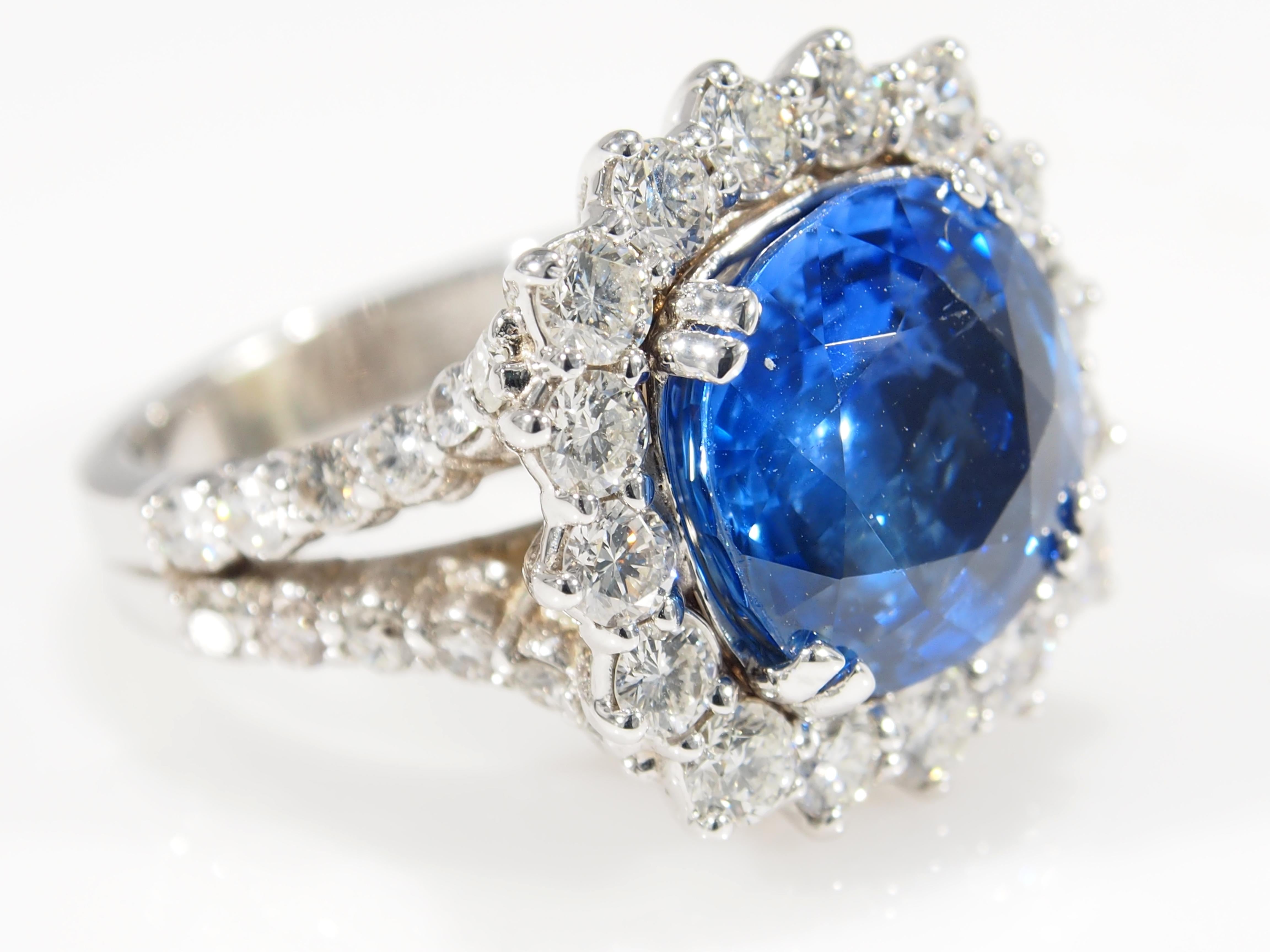 This is a stunning 18K White Gold Diamond and Sapphire Ring. A classically designed ring with a magnificent 8.60ct Cushion Cut Sapphire that is accented by a sparkling Diamond Halo. The Sapphire has a GIA Certificate #1182586049. There are (40)