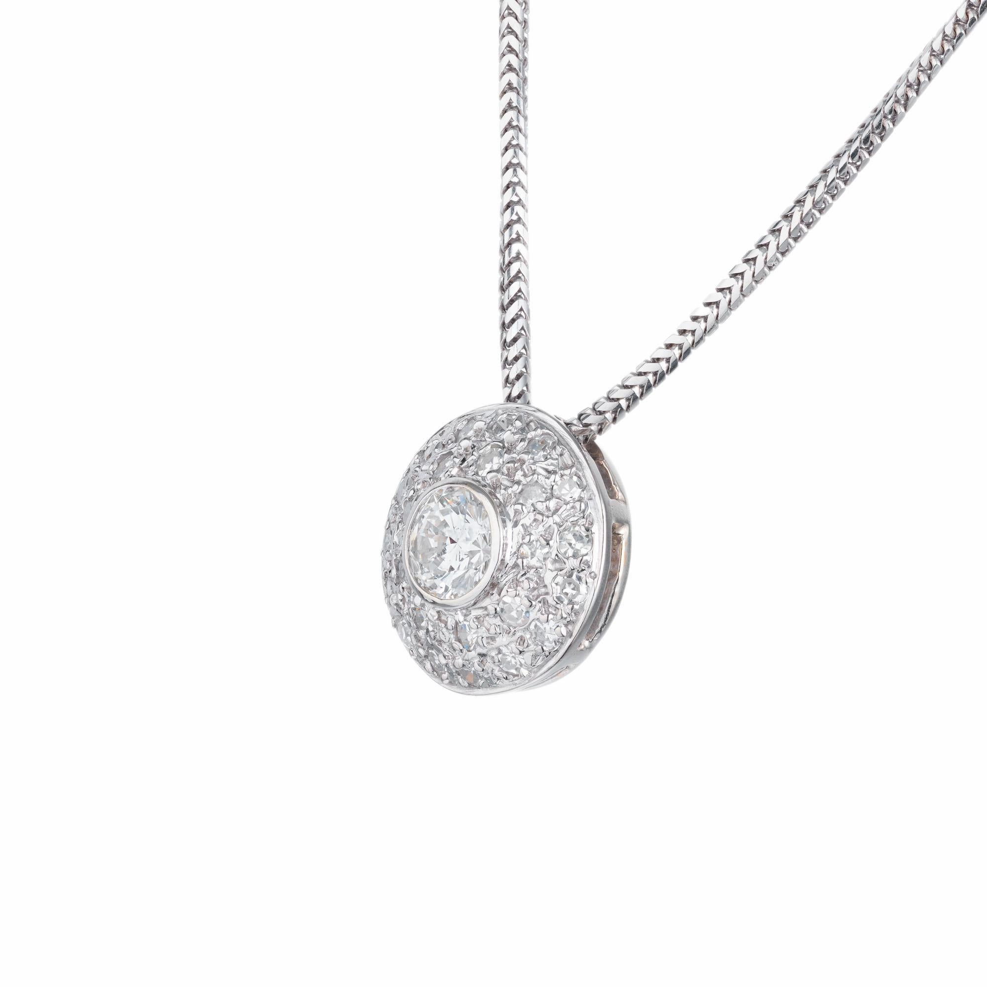 Diamond domed pendant necklace. .53ct center bezel set diamond with a halo of 25 pave set diamonds in 14k white gold. 18 inch snake style chain. 

1 round diamond approx. total weight .53ct, G, SI1.
25 round diamonds approx. total weight .46cts, G,