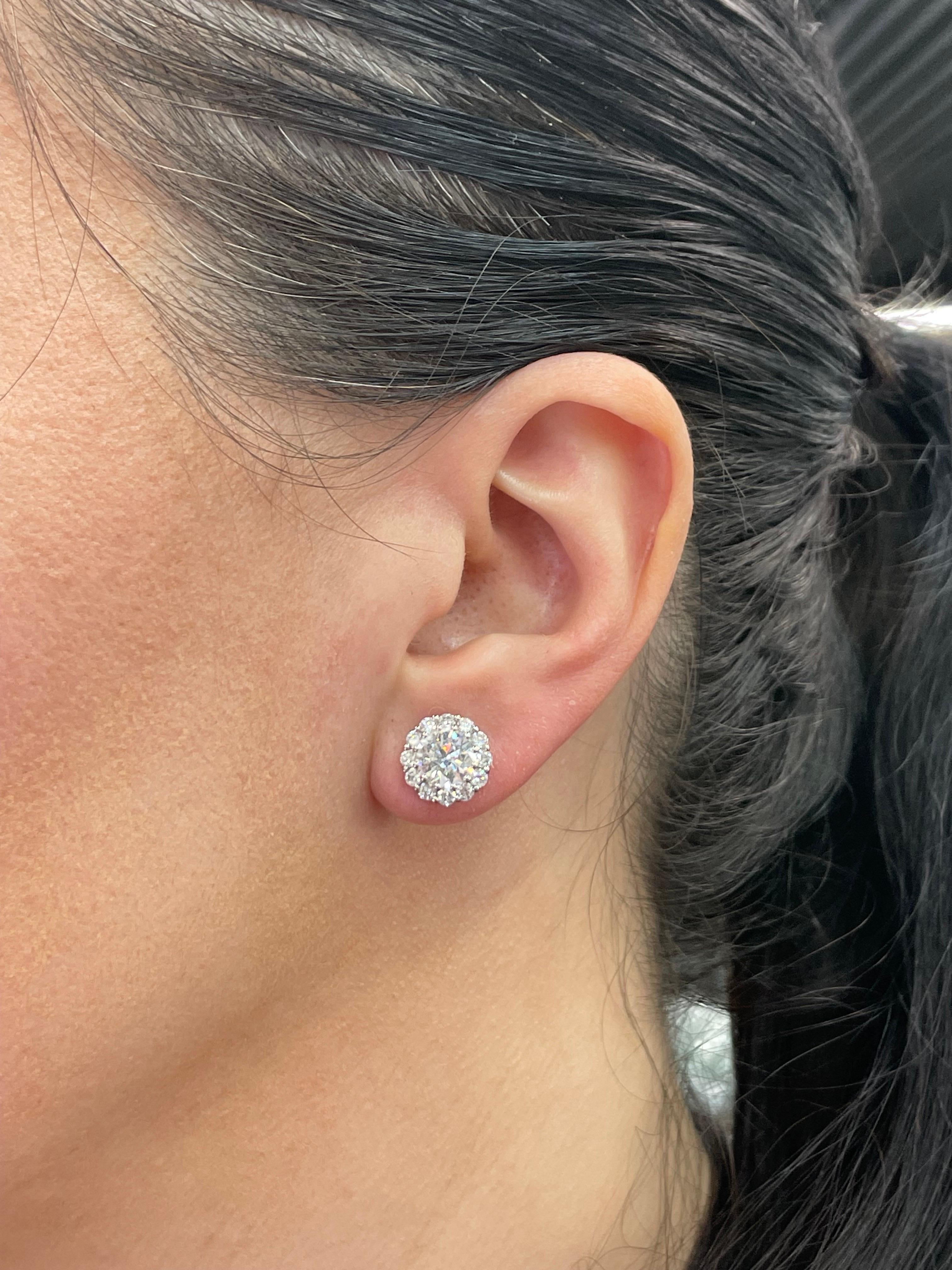 Diamond Stud earrings weighing 3.07 Carats in a 4 prong Champagne Setting, flanked with diamond halo weighing 1.25 carats in 18 Karat White Gold. 
Color H
Clarity SI3-I1
White Color, Clean to the Eye
Studs can be sold without halo.
Call/Message us