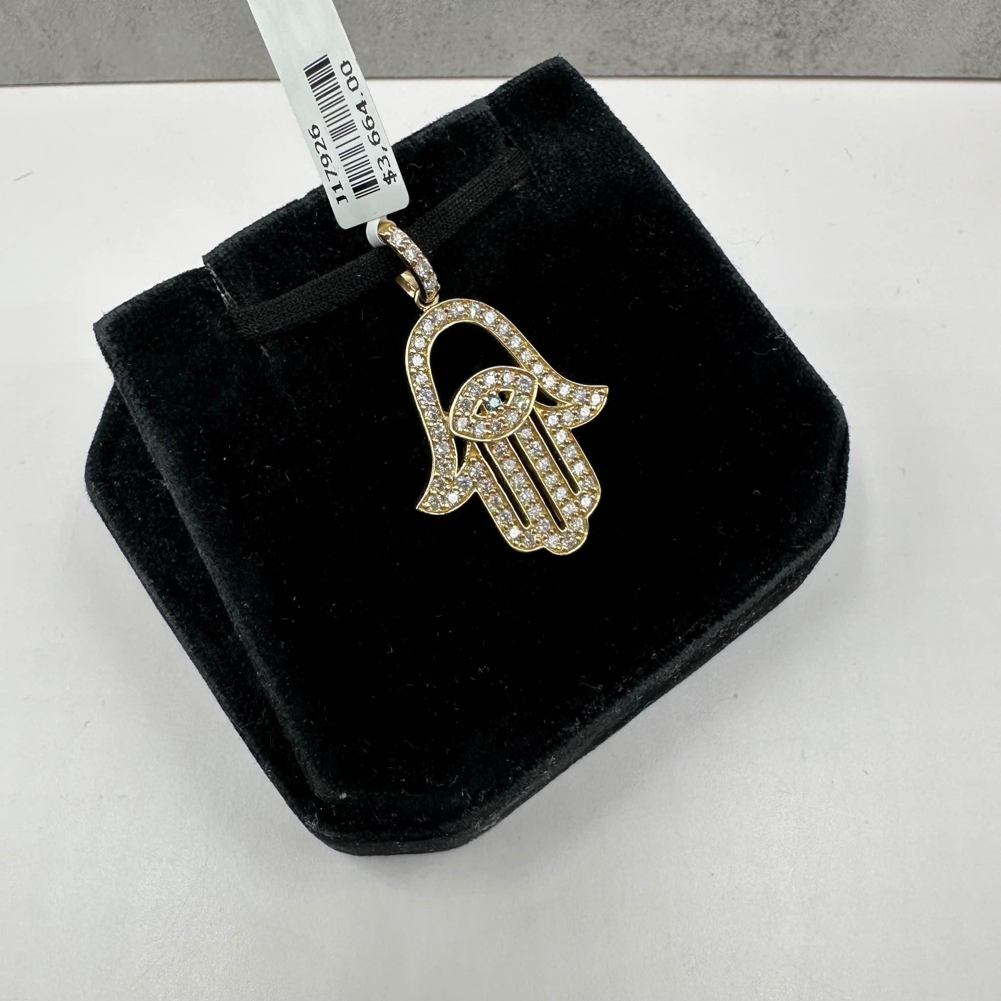This stunning Diamond Hamsa Pendant in 14kt yellow gold features 0.98ctw of natural FG SI round diamonds, with one blue irradiated round diamond for added color and contrast. Weighing 3.7 grams, this pendant offers a substantial yet comfortable