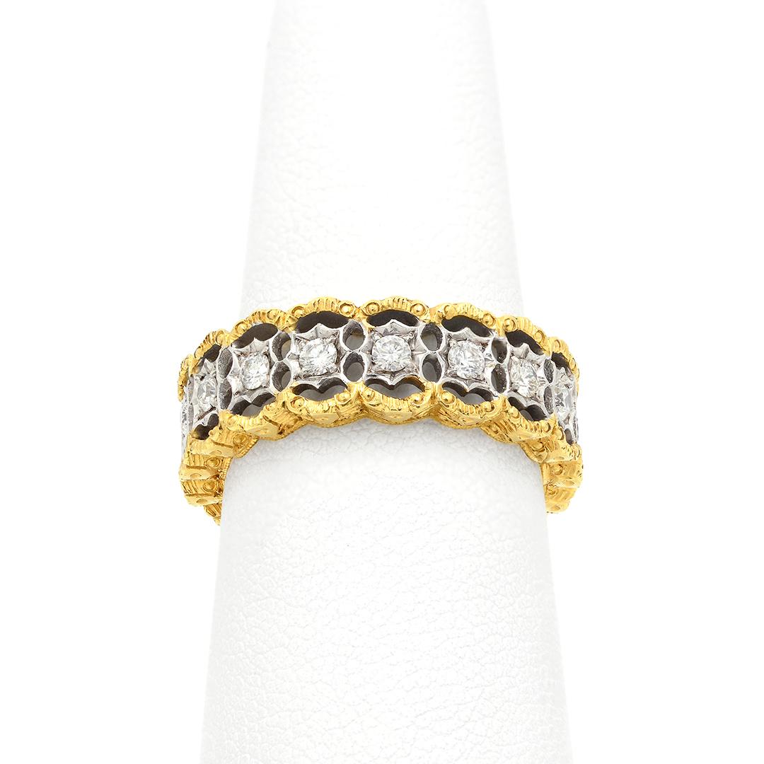 In a vintage filigree inspired design, this eternity band features 17 round brilliant cut diamonds weighing approximately 0.68 carats combined. The diamonds have G-H color and VS clarity. Each diamond is surrounded by 18 karat yellow and white gold