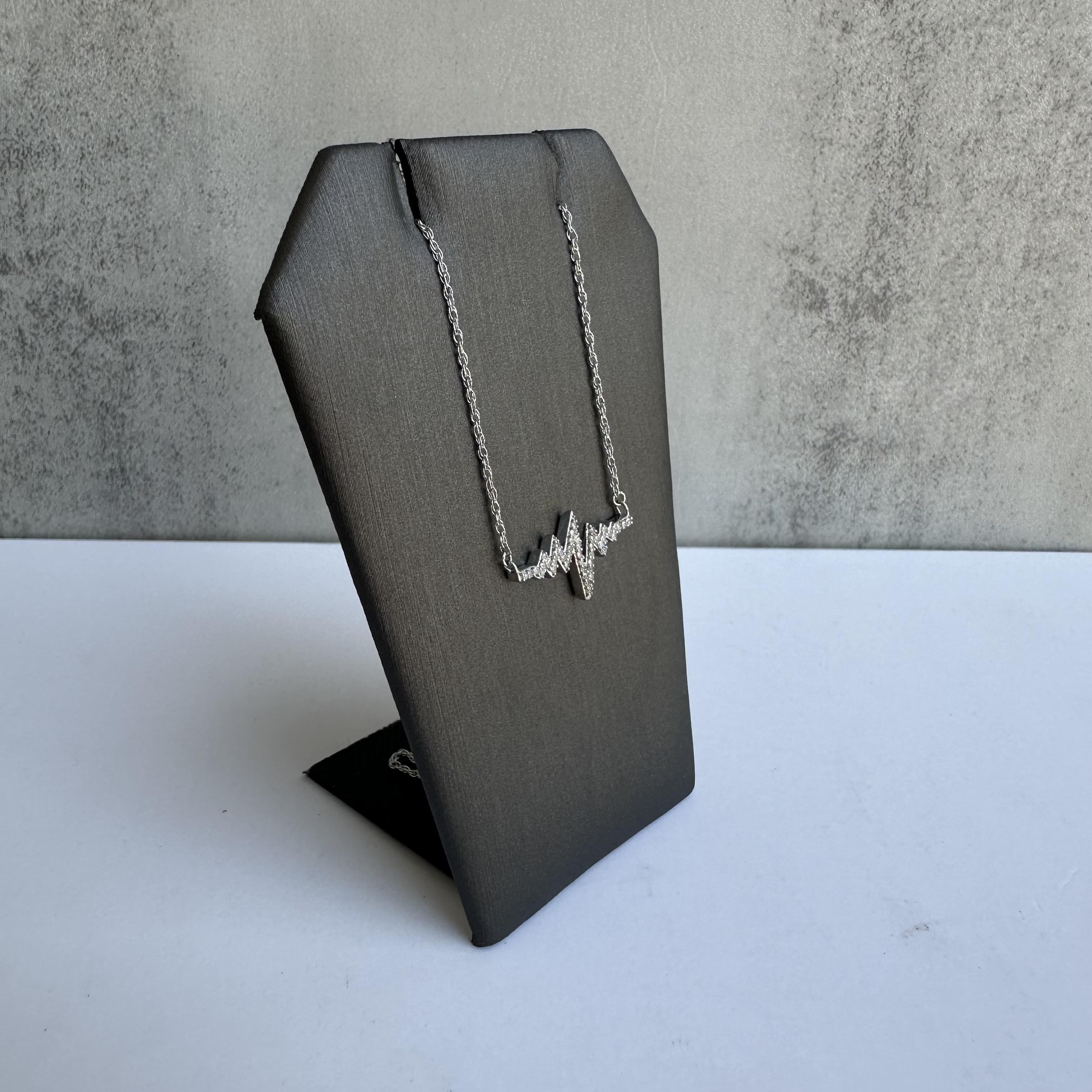 Add a touch of elegance and sentiment to your jewelry collection with this Diamond Heart Beat Necklace in Sterling Silver. Featuring a modern design that symbolizes love and life, this necklace is adorned with 0.18ctw of natural diamonds, making it