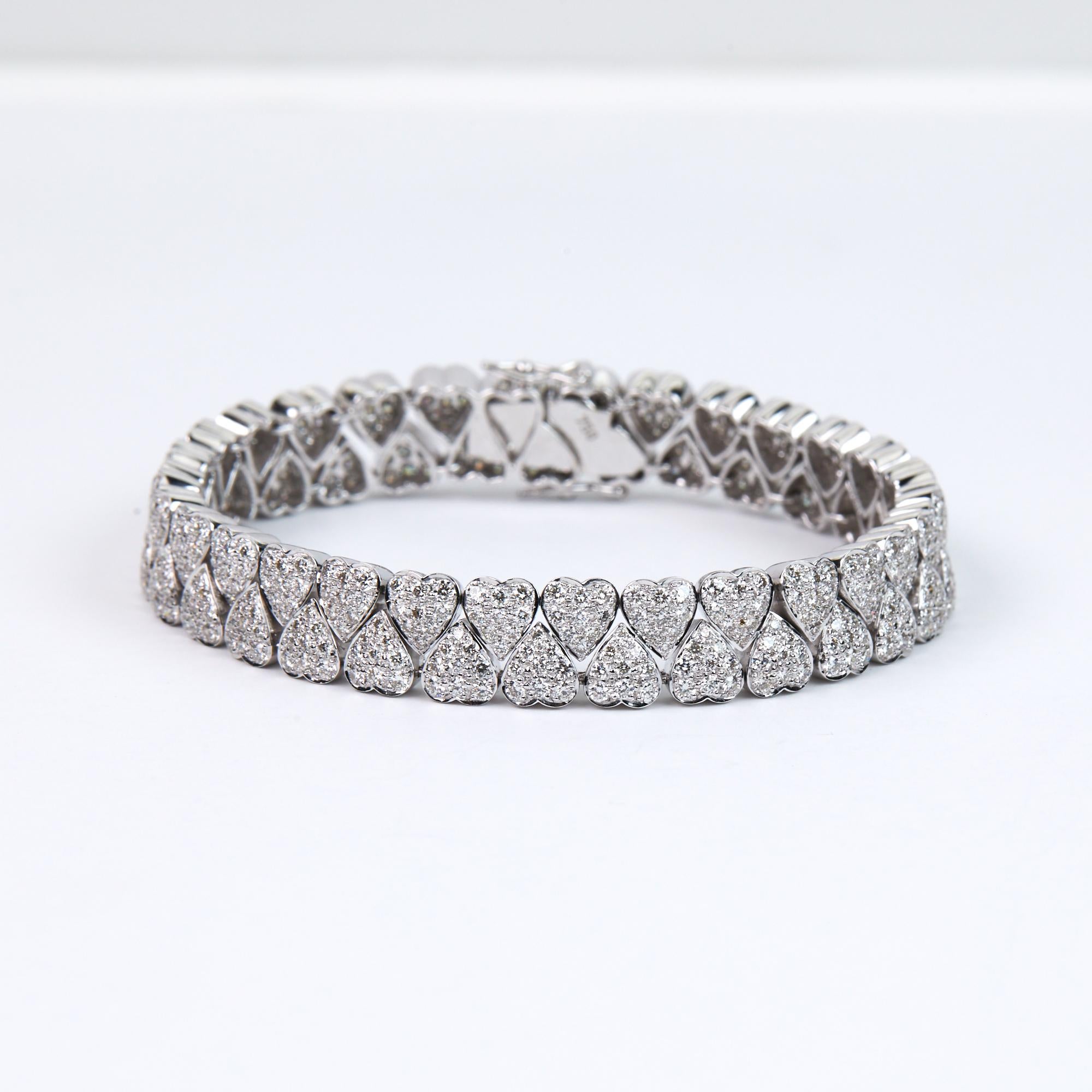 Diamond Heart Bracelet with 6.45 carats of brilliant round cut diamonds.  This modern Bracelet has heart shapes with pavé set diamonds in 18 karat white gold.  Hand made in India for us with a matching necklace available through 1stdibs.  We source