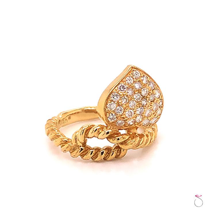 Beautiful vintage diamond cocktail ring in 18K yellow gold. The ring features a heart design pave' set with round diamonds totaling 0.50 ct. All the diamonds are G - H in color and VS in clarity. The ring shank has a rope design that swirl at the