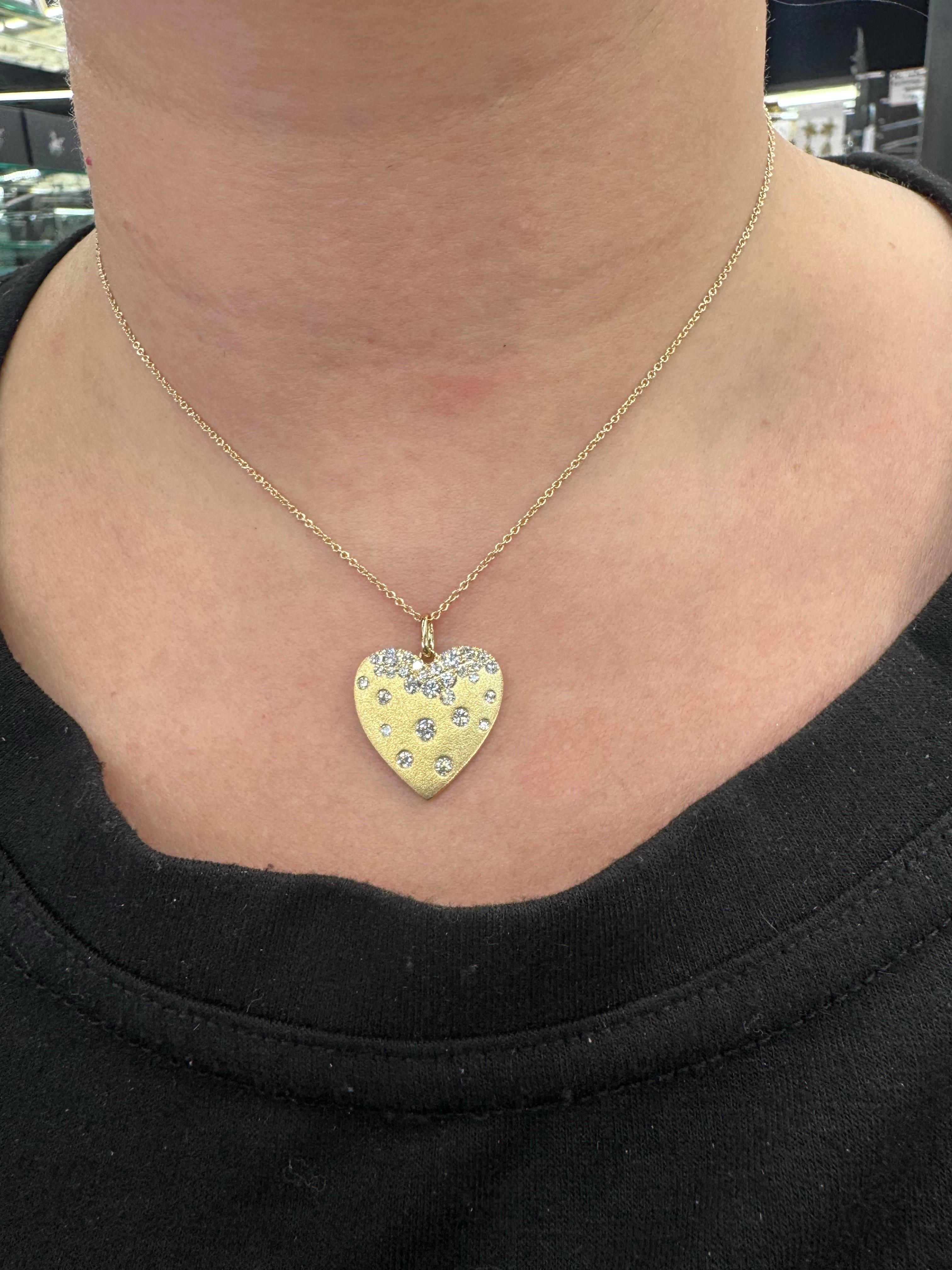 Questo romantico ciondolo a forma di cuore a coriandoli è splendidamente realizzato in oro giallo 14K e incastonato con 29 diamanti rotondi taglio brillante per un totale di 0,90 carati. I diamanti sono sparsi ad arte in un motivo a coriandoli,
