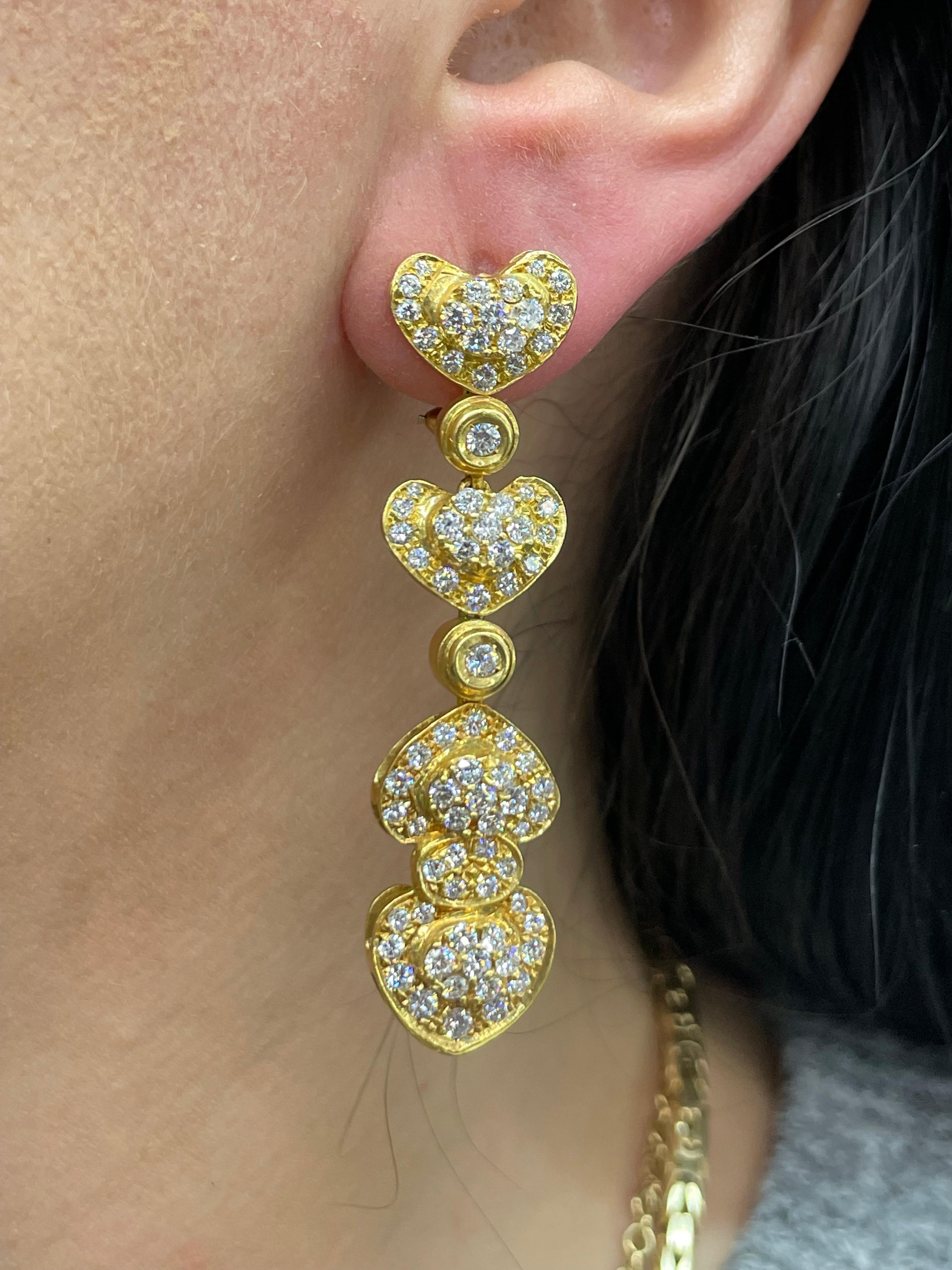 Circa 1980's, this Vintage heart motif diamond drop earrings feature 160 Round Brilliants weighing approximately 4.50 carats.
Color F-G
Clarity SI