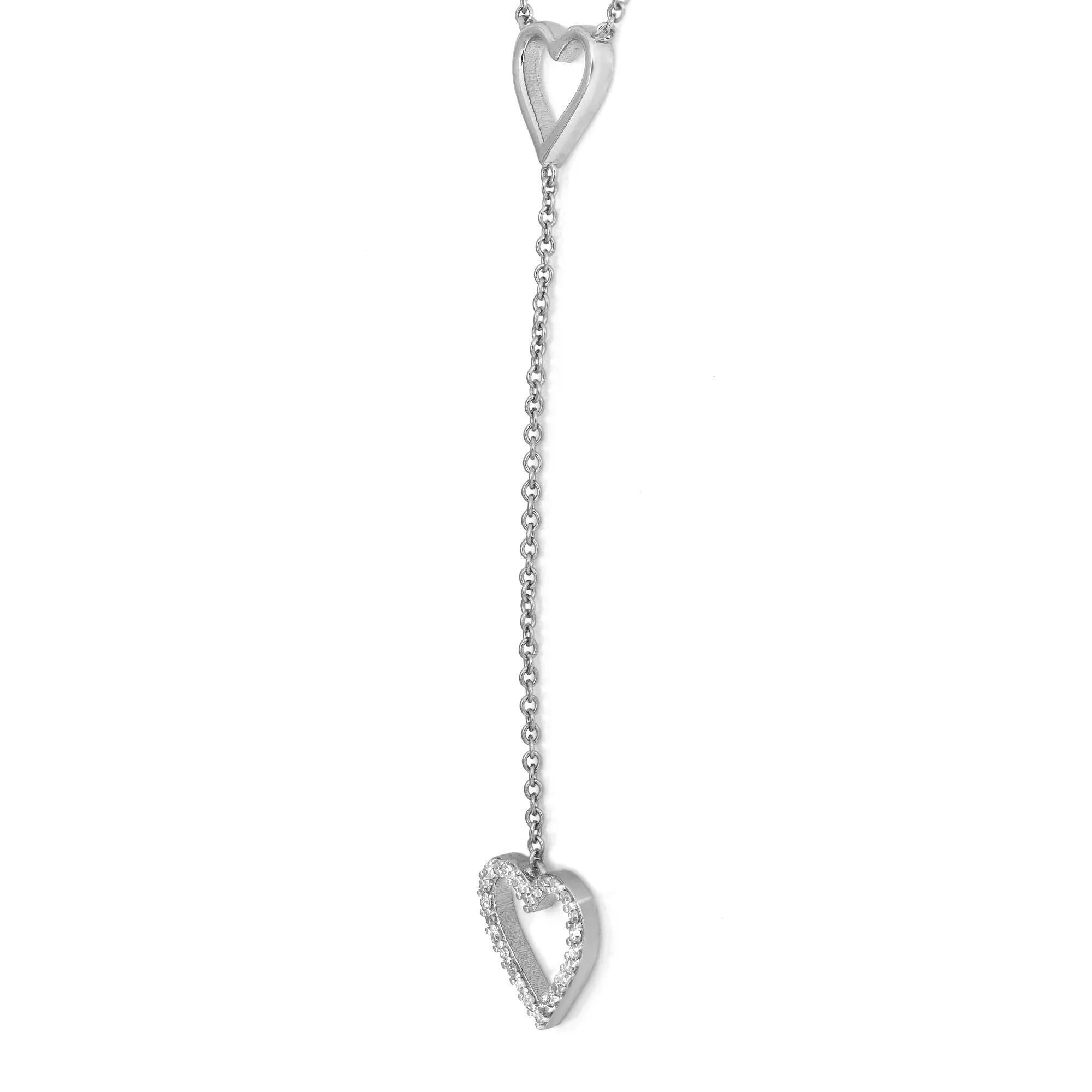 Beautiful and delicate this diamond lariat necklace will leave everyone speechless the moment they see it. Crafted in high polished 14K white gold. It features two pave set diamond studded heart shape motifs with a heart cut out in the center,