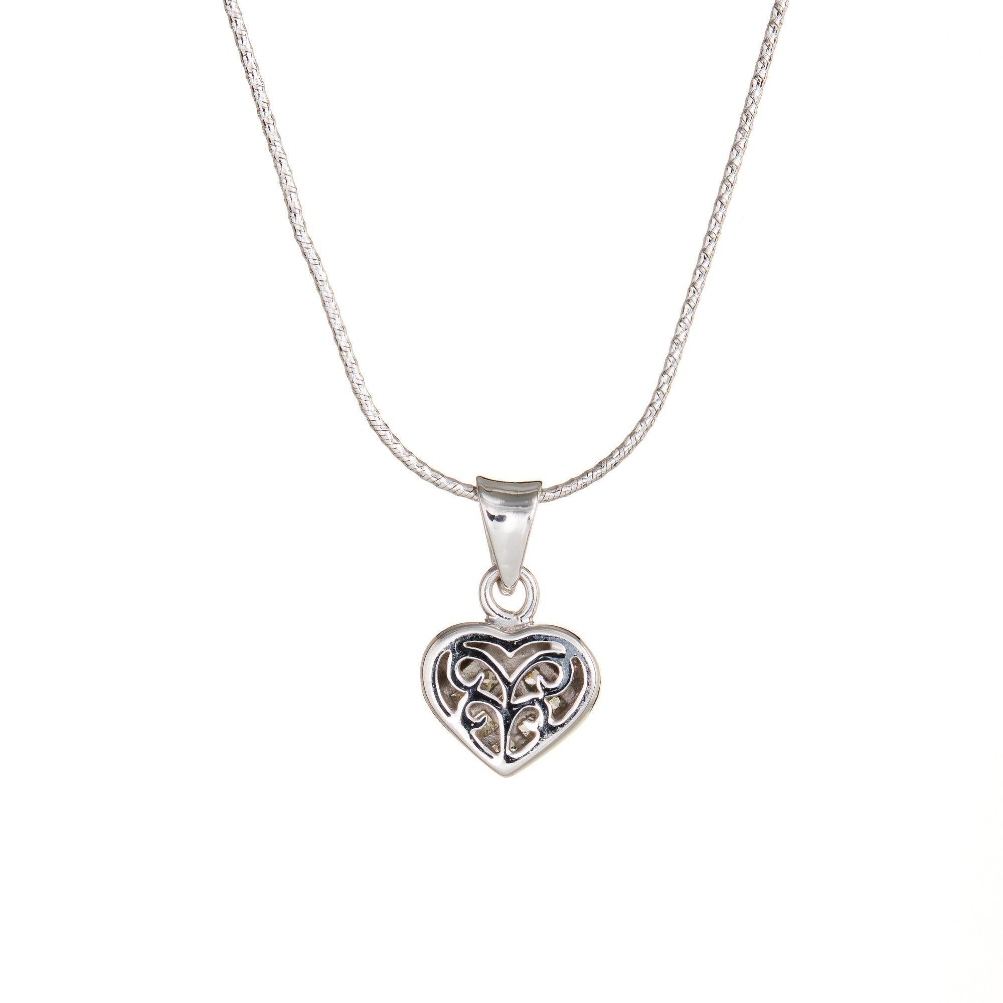Finely detailed estate diamond heart necklace crafted in 18 karat white gold.  

7 princess cut diamonds total an estimated 0.35 carats (estimated at I-J color and SI1-2 clarity).  

The heart features invisibly set princess cut diamonds. The