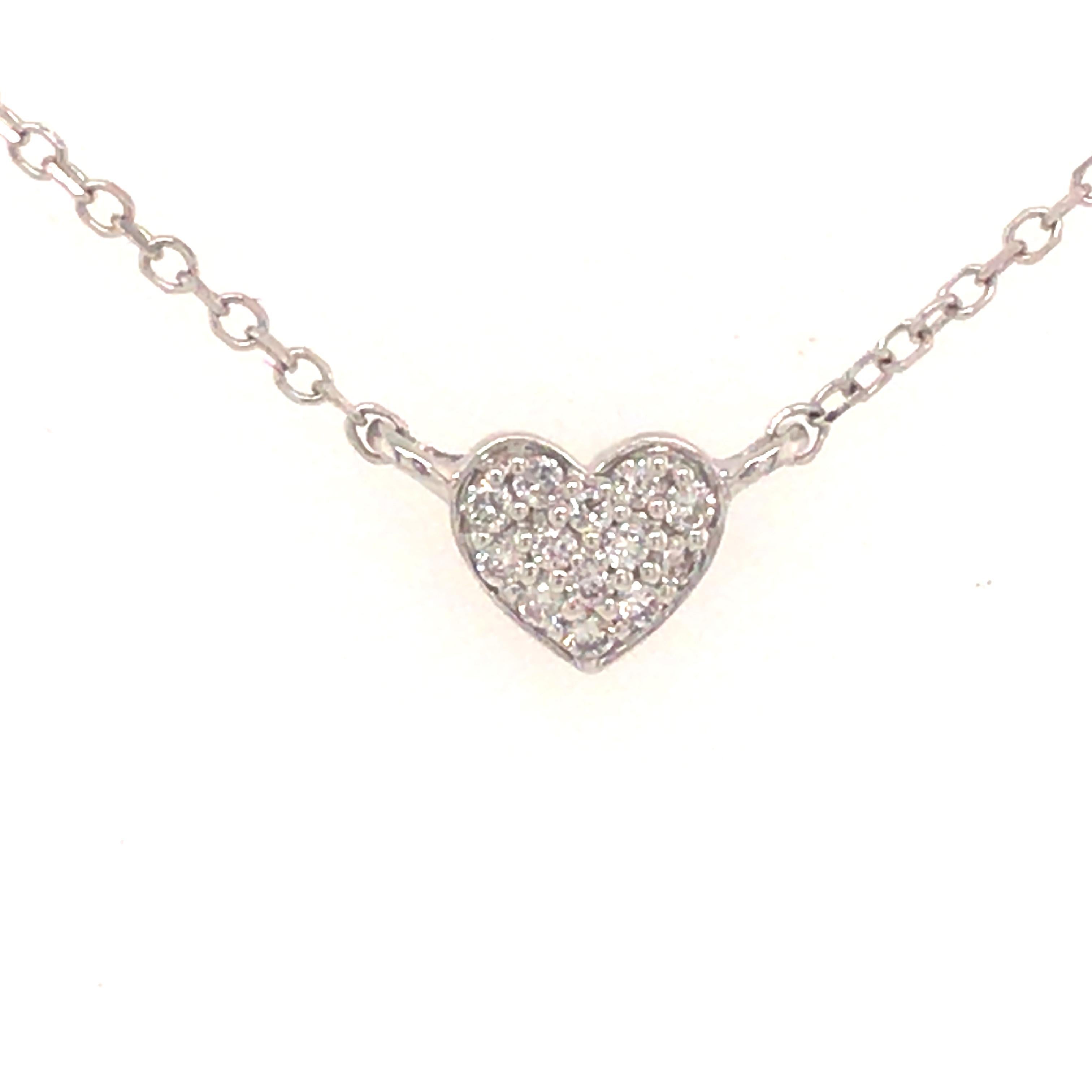 A unique Diamond Heart Shaped Cluster Station Necklace in 14K White Gold.  (5) Heart shaped stations are set with Round Brilliant Cut Diamonds weighing .34 carat total weight, G-H in color and VS-SI in clarity. The necklace is 18 inches in length