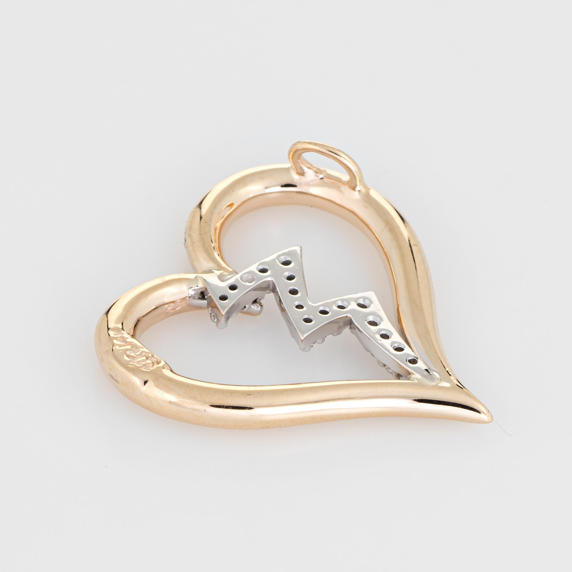 Stylish estate diamond heartbeat pendant crafted in 14 karat yellow gold. 

15 diamonds total an estimated 0.07 carats (estimated at H-I color and VS2-SI1 clarity). 

The distinct pendant features a diamond set heartbeat down the center of the