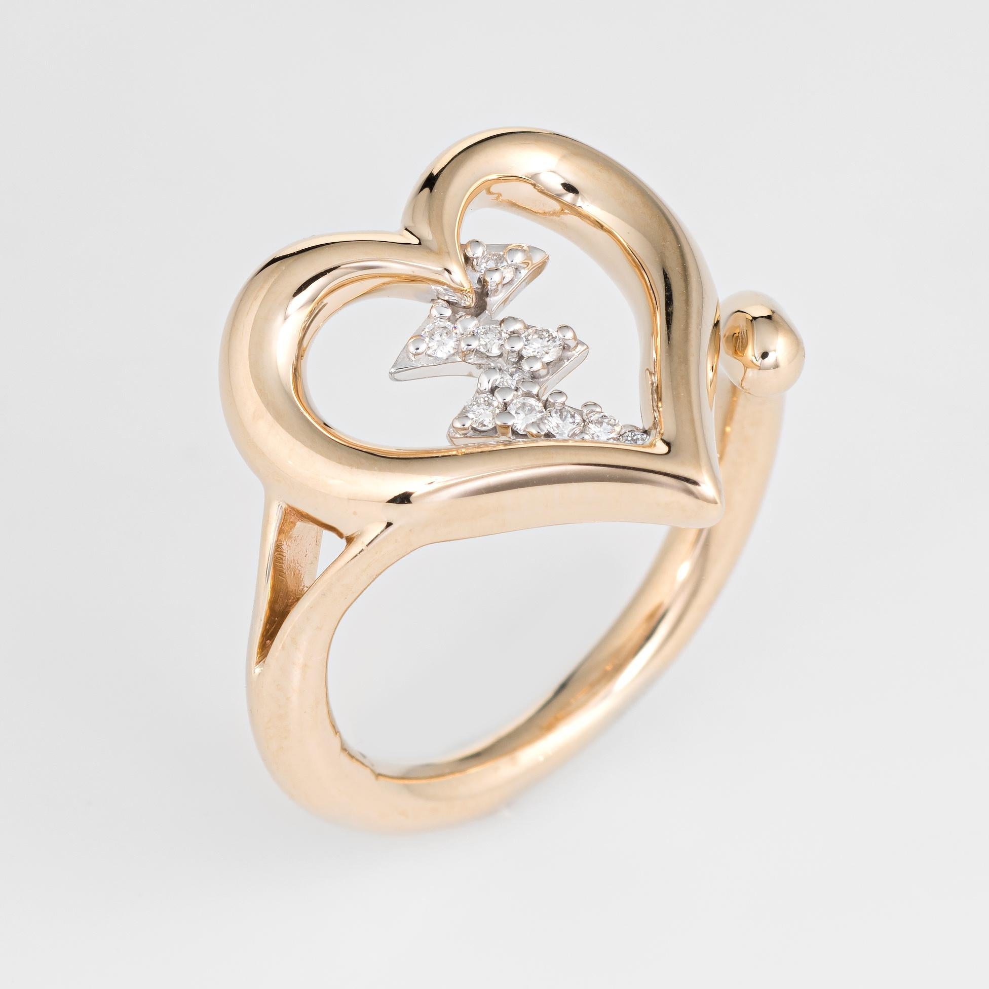 Stylish estate diamond heartbeat ring crafted in 14 karat yellow gold. 

10 diamonds total an estimated 0.05 carats (estimated at H-I color and VS2-SI1 clarity). 

The distinct ring features a diamond set heartbeat down the center of the heart. The