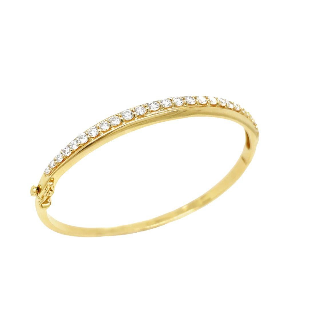 This elegant 18 karat yellow gold bracelet is set with round brilliant cut diamonds, all F-G in color and VS1 in clarity, totaling 2 carats total weight. The classic shared prong design promotes the fine white diamonds in an uninterrupted
