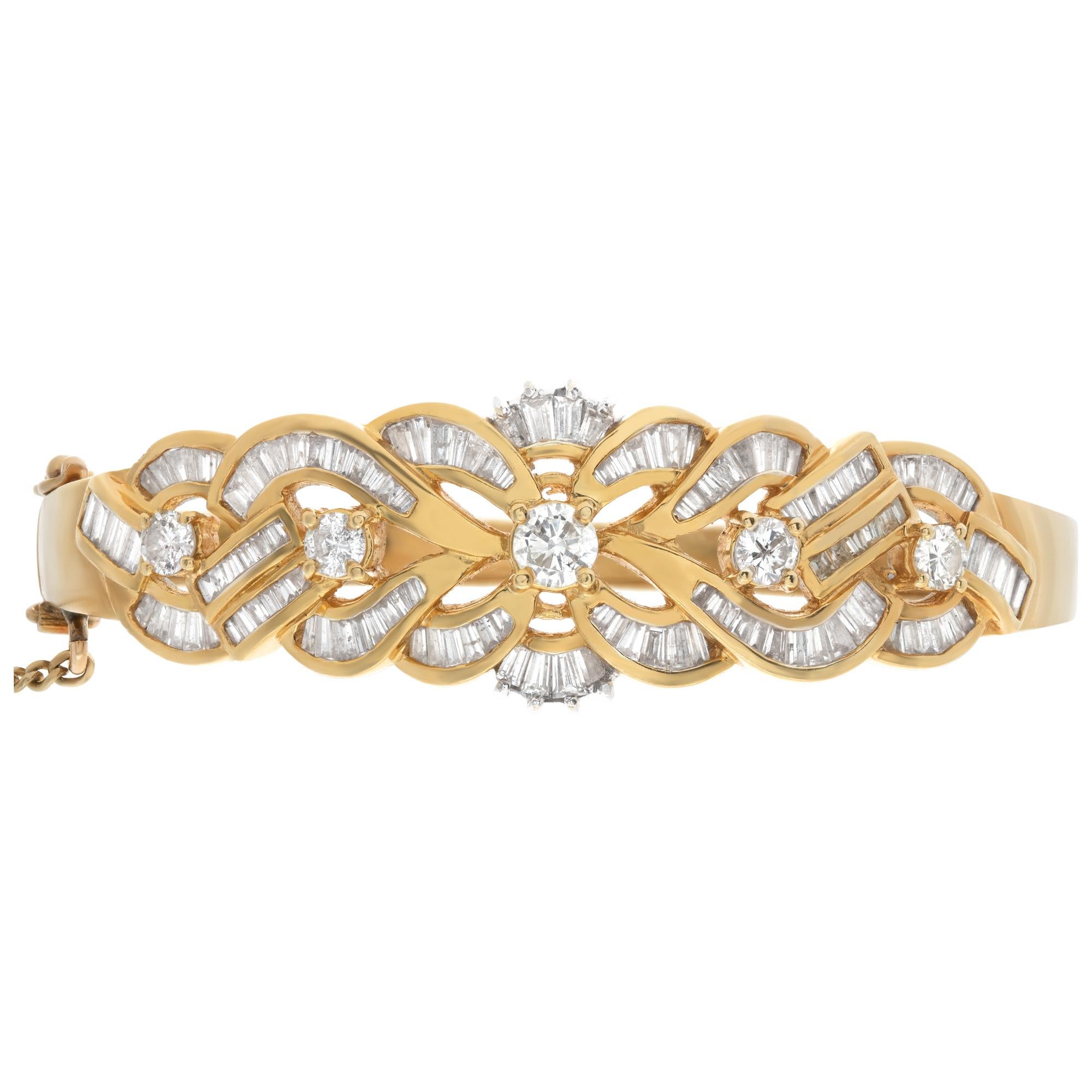 Diamond hinged bangle set in 18k yellow gold. Approx 3 carats of full round brilliant and baguette cut diamonds. G-H color, S1 clarity. Box clasp with dounble security latches and security chain. Fits wrist up to 6.75 inches