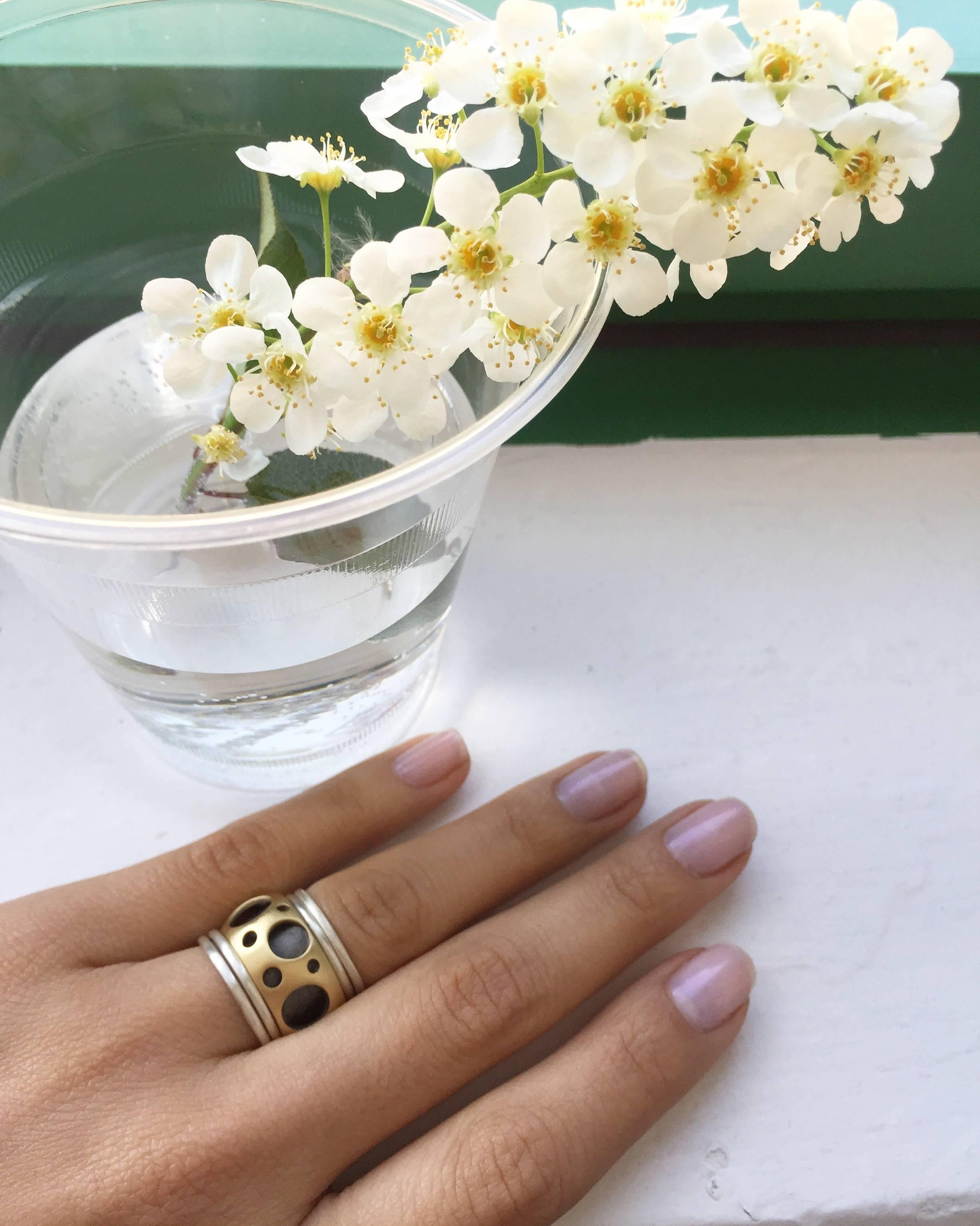 The Hollow Ring is one of Dana's first designs, and it consists of two connected rings. The outer layer of which features diamonds and Dana's signature 