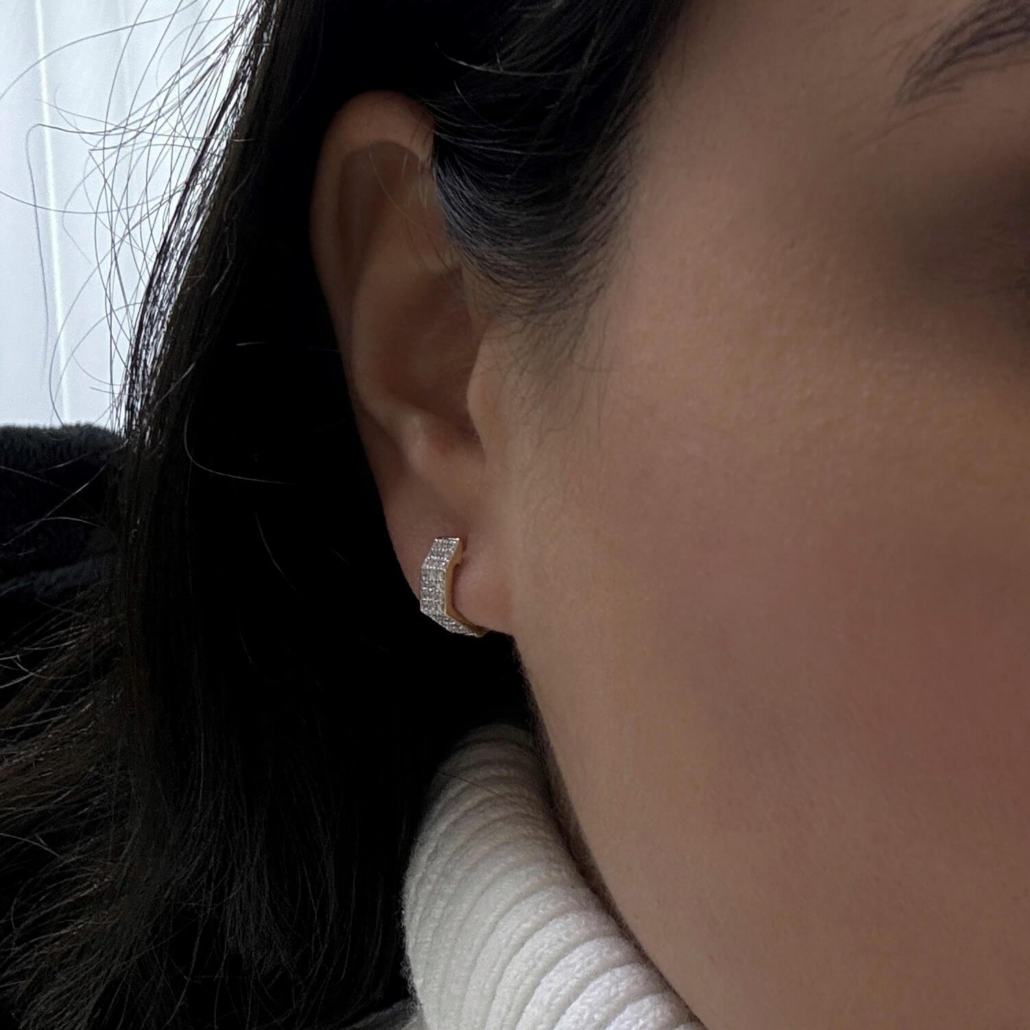 Elevate your everyday style with this diamond and 14k gold huggies. As the perfect piece to wear every day, these hexagon shaped huggies are an Essential for your jewelry collection. The huggies feature three rows of diamonds that give an extra