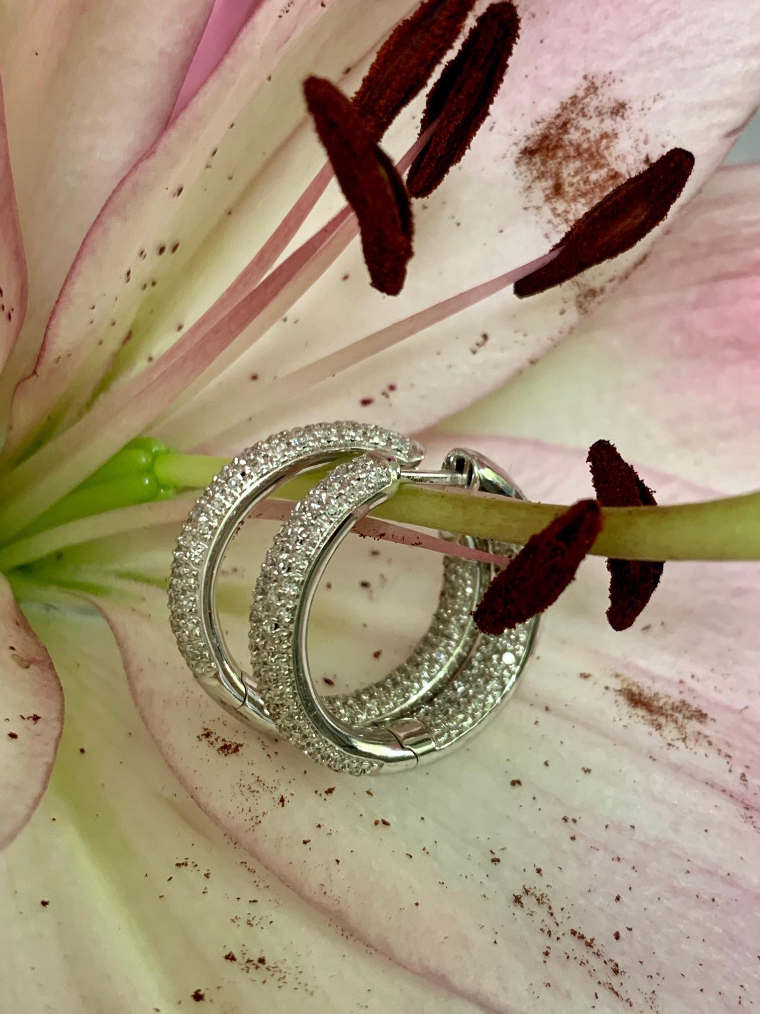 These beautiful diamond hoop earrings are stunning.  The diamonds are on the outside of the hoop in the front and on the inside of the hoop in the back.  The resulting effect, is that ALL of the diamonds are visible, all the time. 

They are
