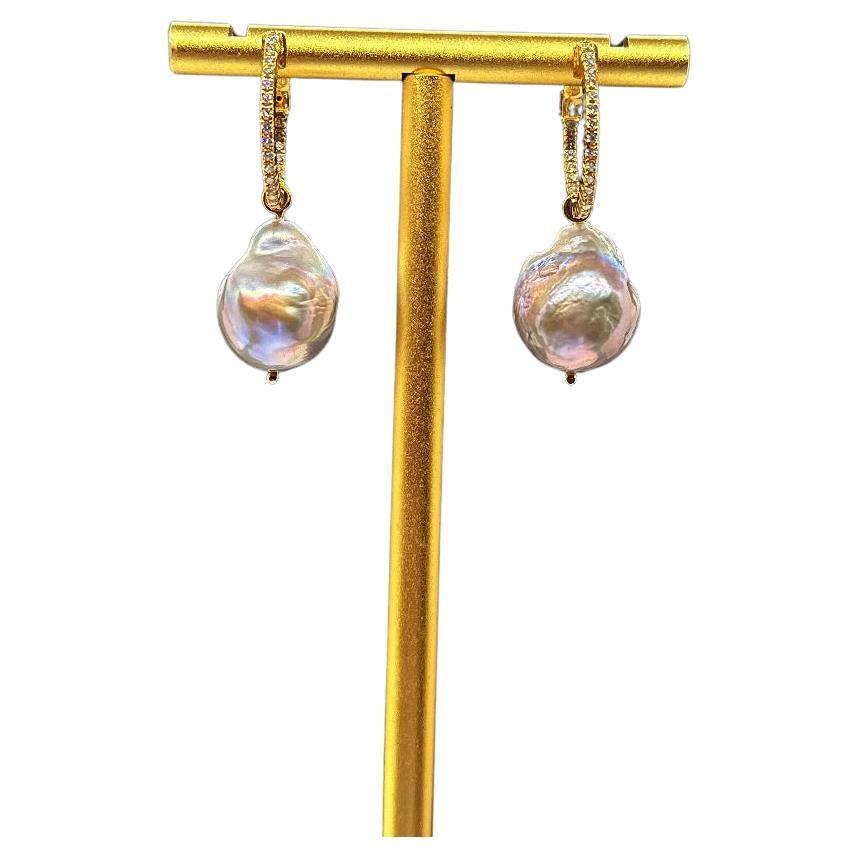 50-round brilliant diamonds

14k Yellow Gold

Total carat weight: 0.50 ct

GHSI1 quality (natural diamonds)

Prong setting

0.75mm width (hoop earring)
Safety push button clasp
In and out diamonds

Grey baroque pearls hanging by a loop (