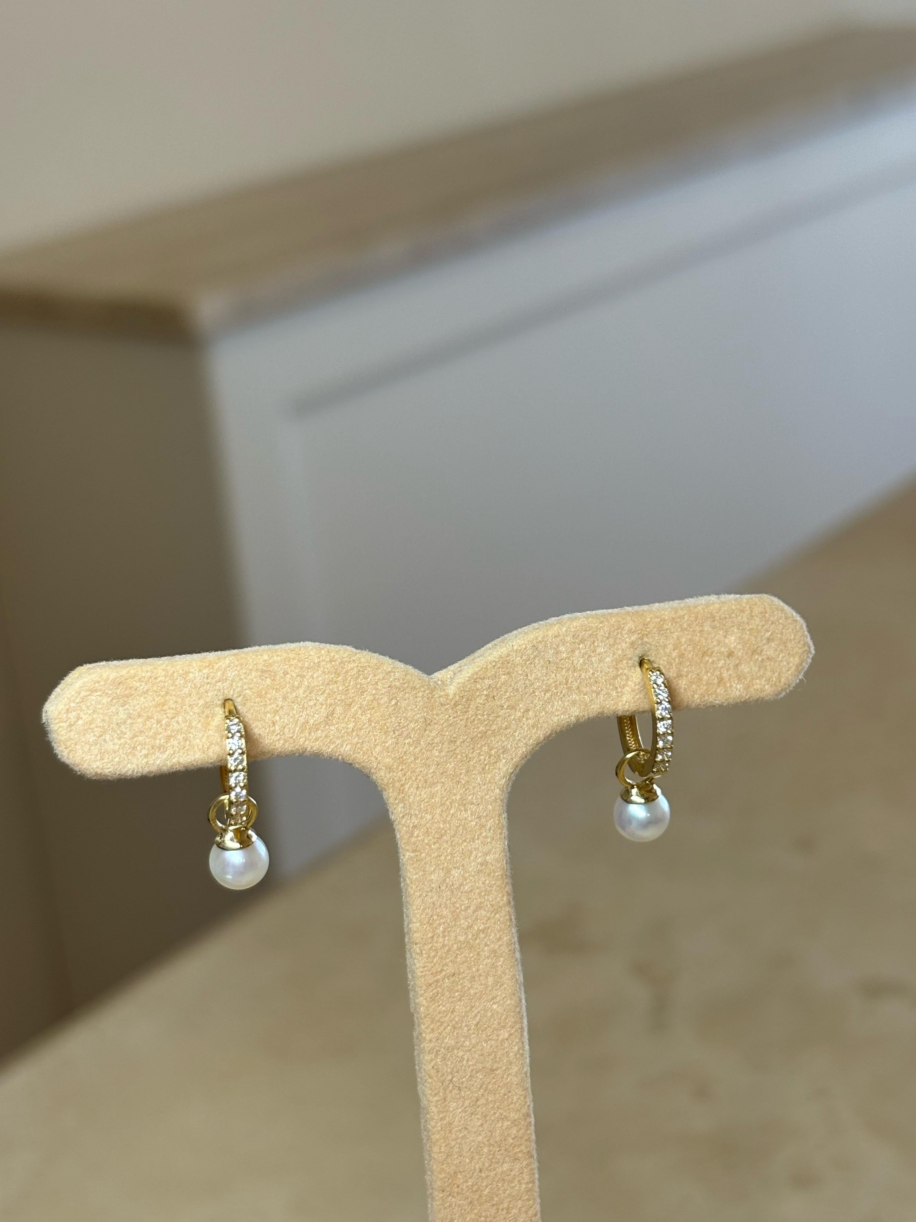 Our Diamond Huggies are crafted from 18Karat Yellow Gold and set with glimmering natural diamonds. These earrings are the absolute everyday staple to complete any ear party look. The dangling mini pearls can be easily detached from the earrings.