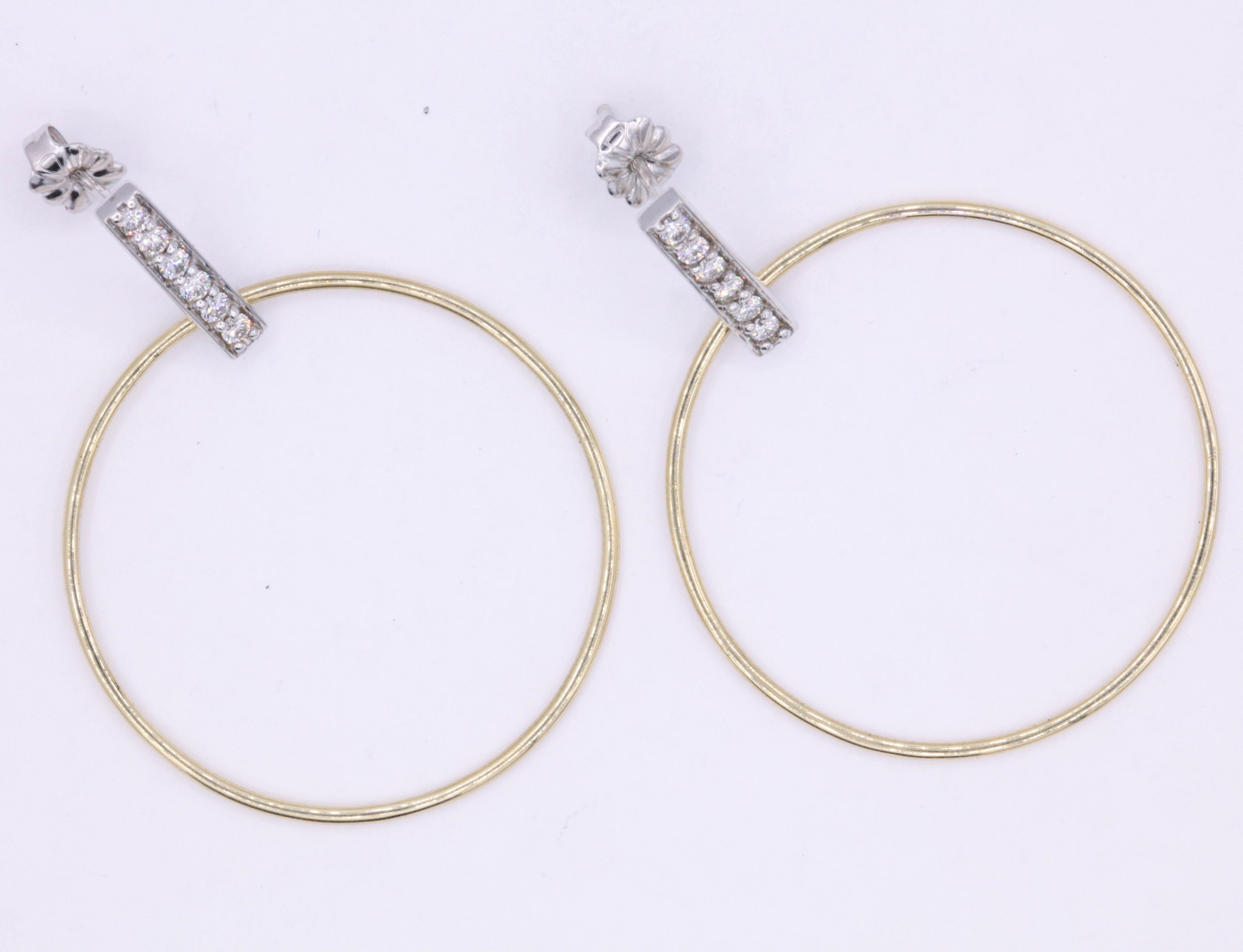 These fun and playful hoop earrings feature a diamond bar with 12 round brilliants weighing 0.33 carats, in 14k white and yellow gold. 
Color: G-H
Clarity: SI