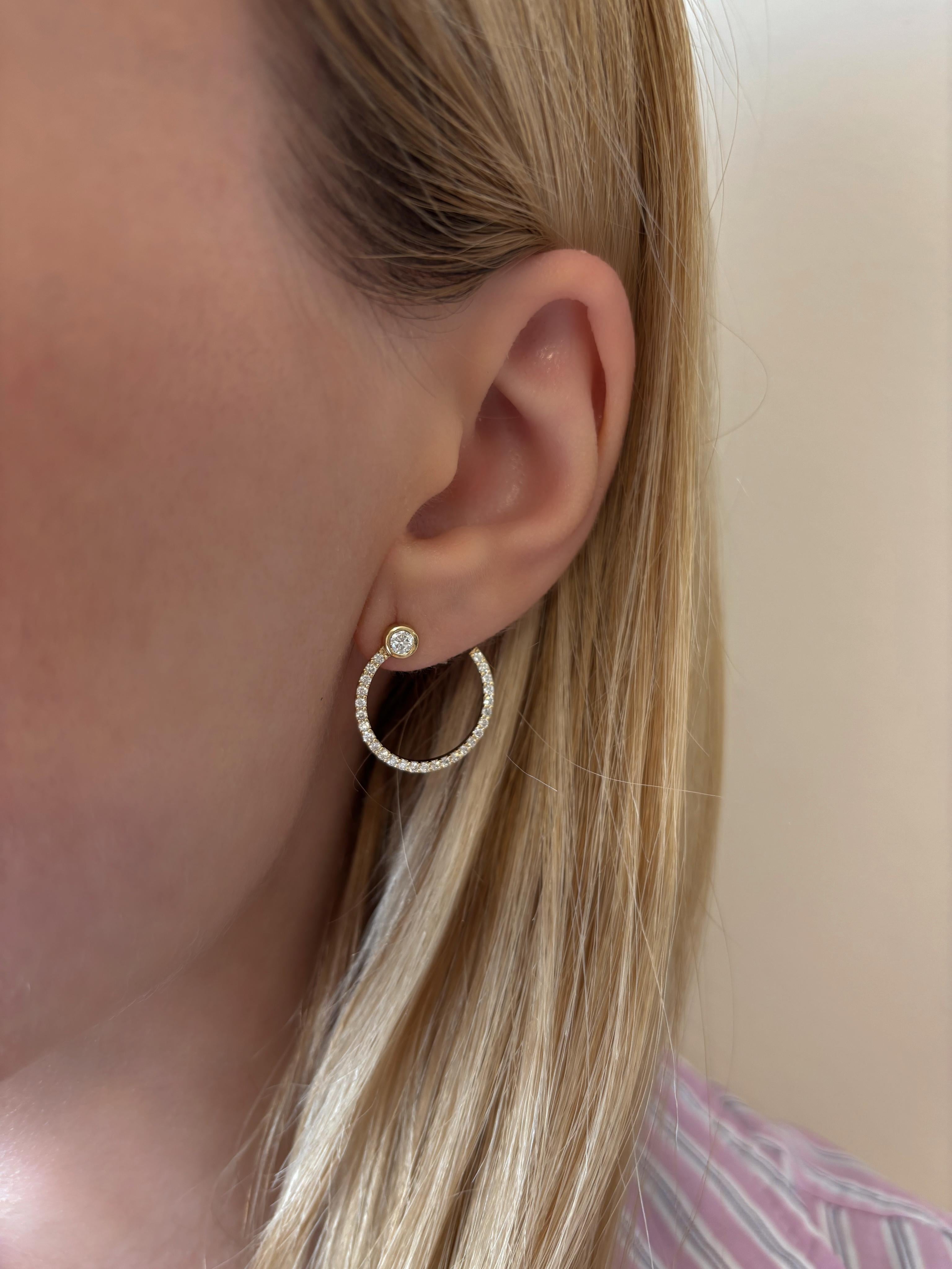 The ‘Eternal Diamond’ hoop earrings offer a modern approach to the classic diamond hoop silhouette.

The pair is made with 18 Karat yellow gold and is illuminated by a bezel set diamond at the top along with glimmering diamonds along the hoop. Their