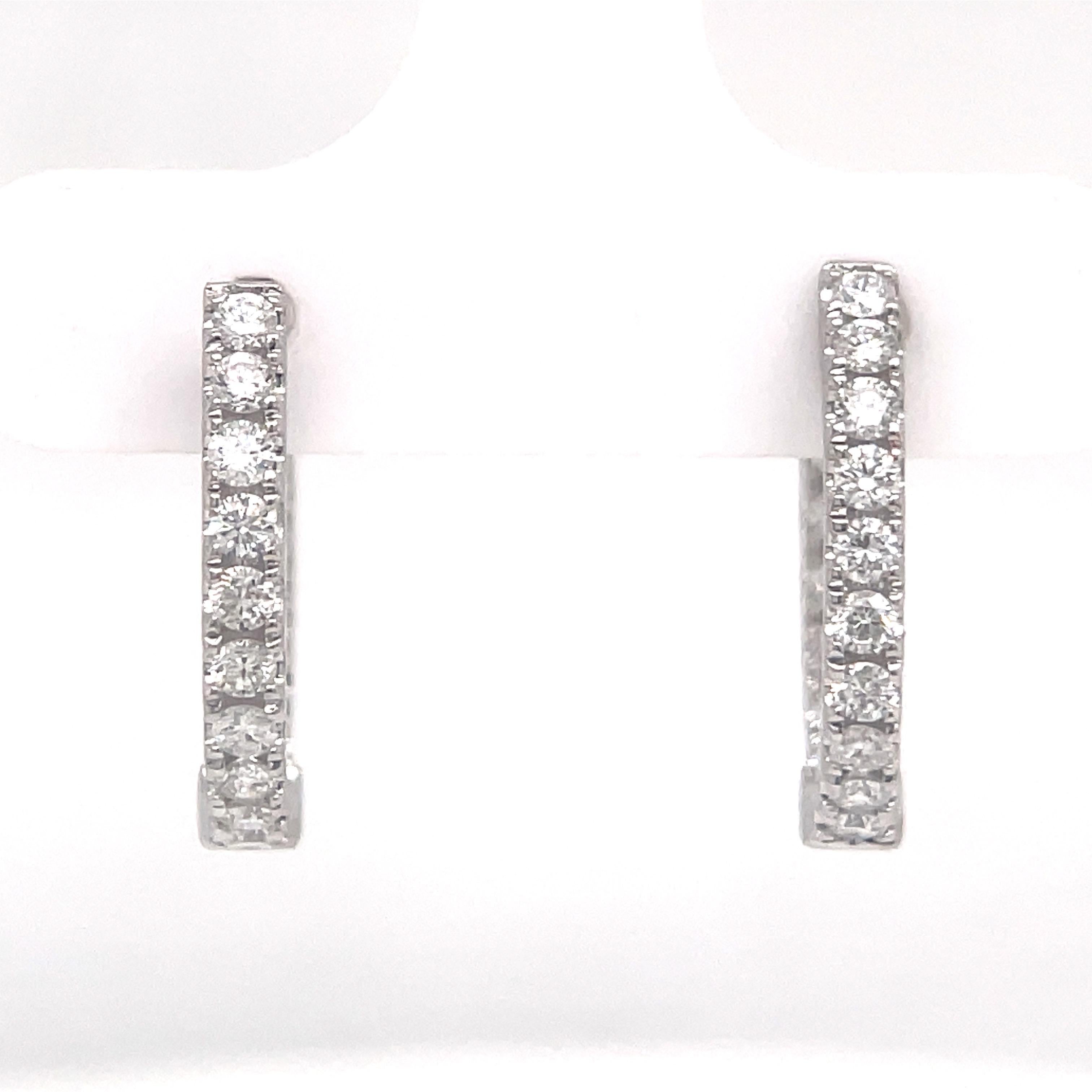 Diamond hoop earrings featuring 32 round brilliants weighing 0.82 carats, set in 14 karat white gold.
Color G-H
Clarity SI

