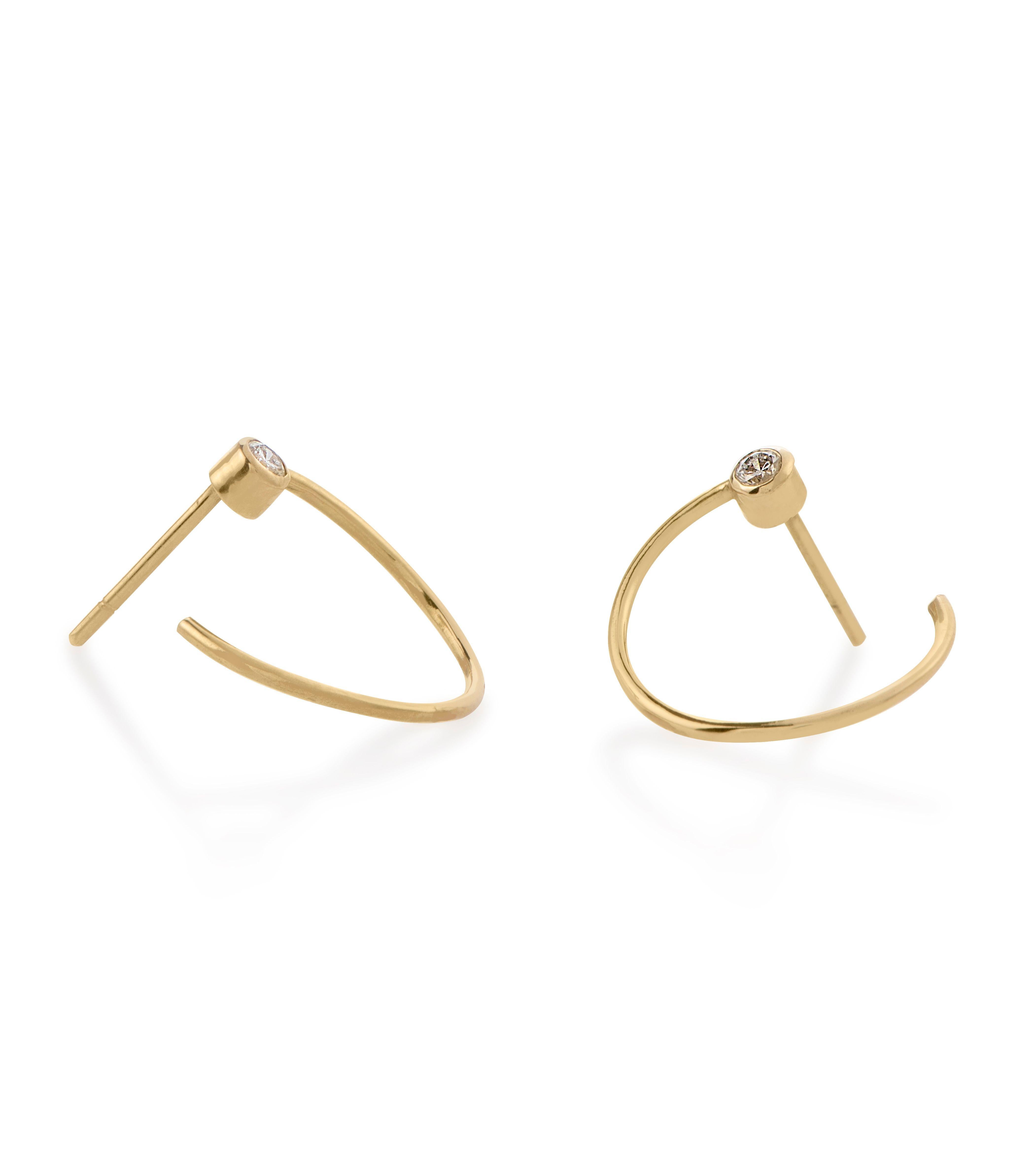 The Eternal Hoop Earrings are handcrafted in 18Karat yellow gold and illuminated by bezel set natural diamonds. Their modern and minimal silhouette makes them ideal for everyday wear.

All orders are delivered in a black velvet jewellery box, a gift