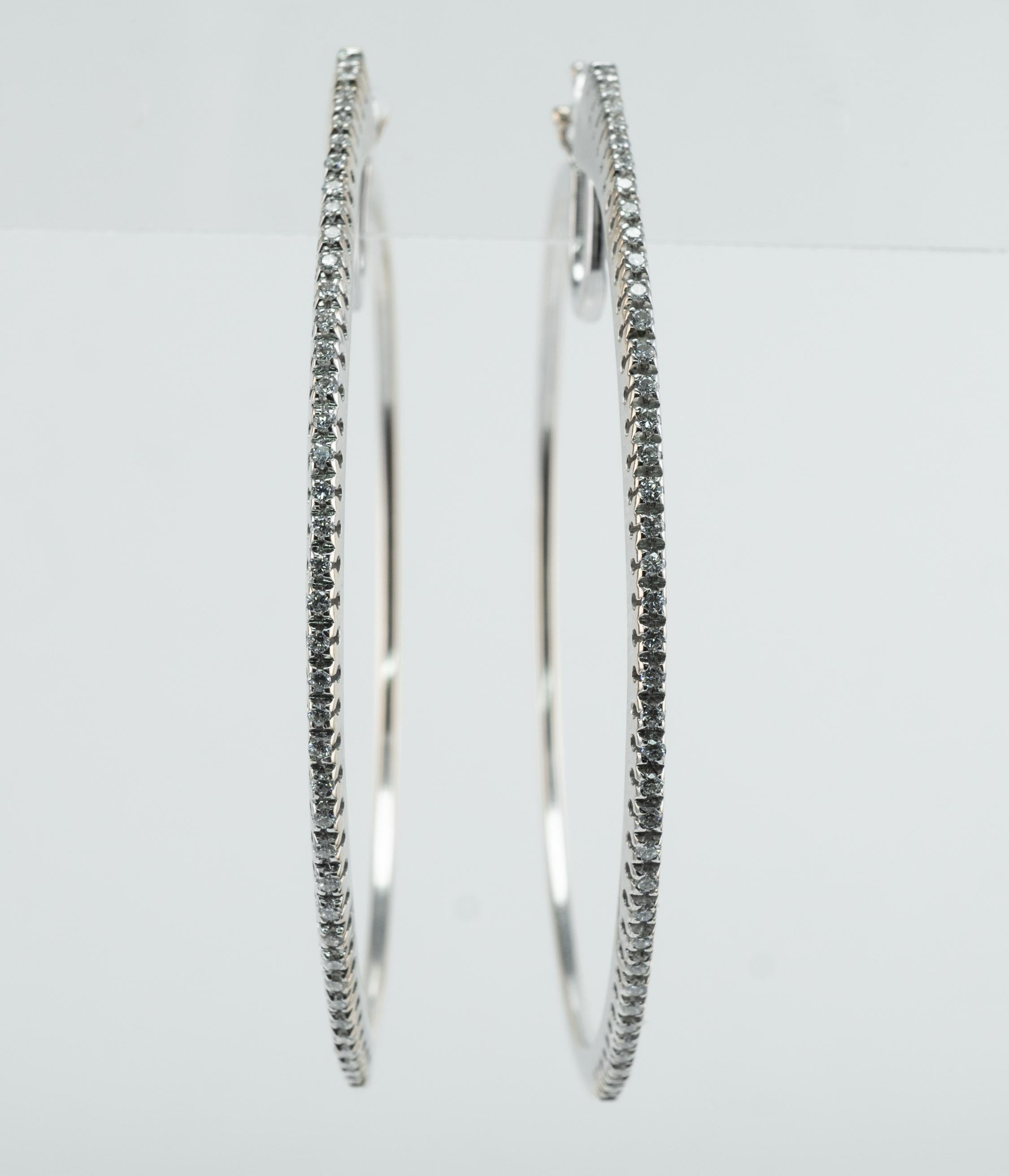 Diamond Hoop Earrings 18K White Gold by Diadema

This beautiful estate pair of earrings if finely crafted in solid 18K White gold by Italian jewelry company Diadema. There are 40 white and clean diamonds in each earring. The total diamond weight is