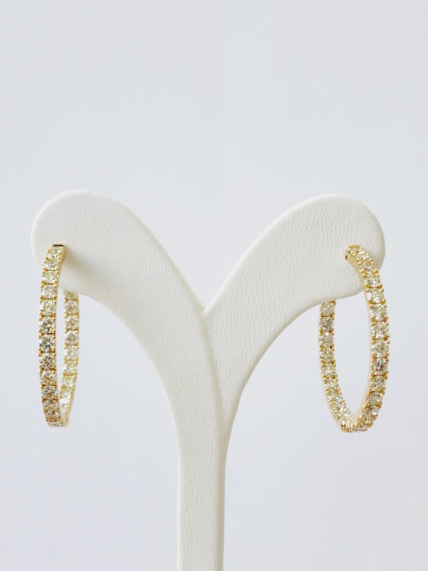 Round Diamond Hoops Earrings Total 4.25 Carat in 18 K Yellow Gold 
Finely arranged round diamonds assorted elegantly in 18 K White Gold hoops for full exposure of 4.25 Carat of natural diamonds! Fun and elegant Hoop Earrings made to create an