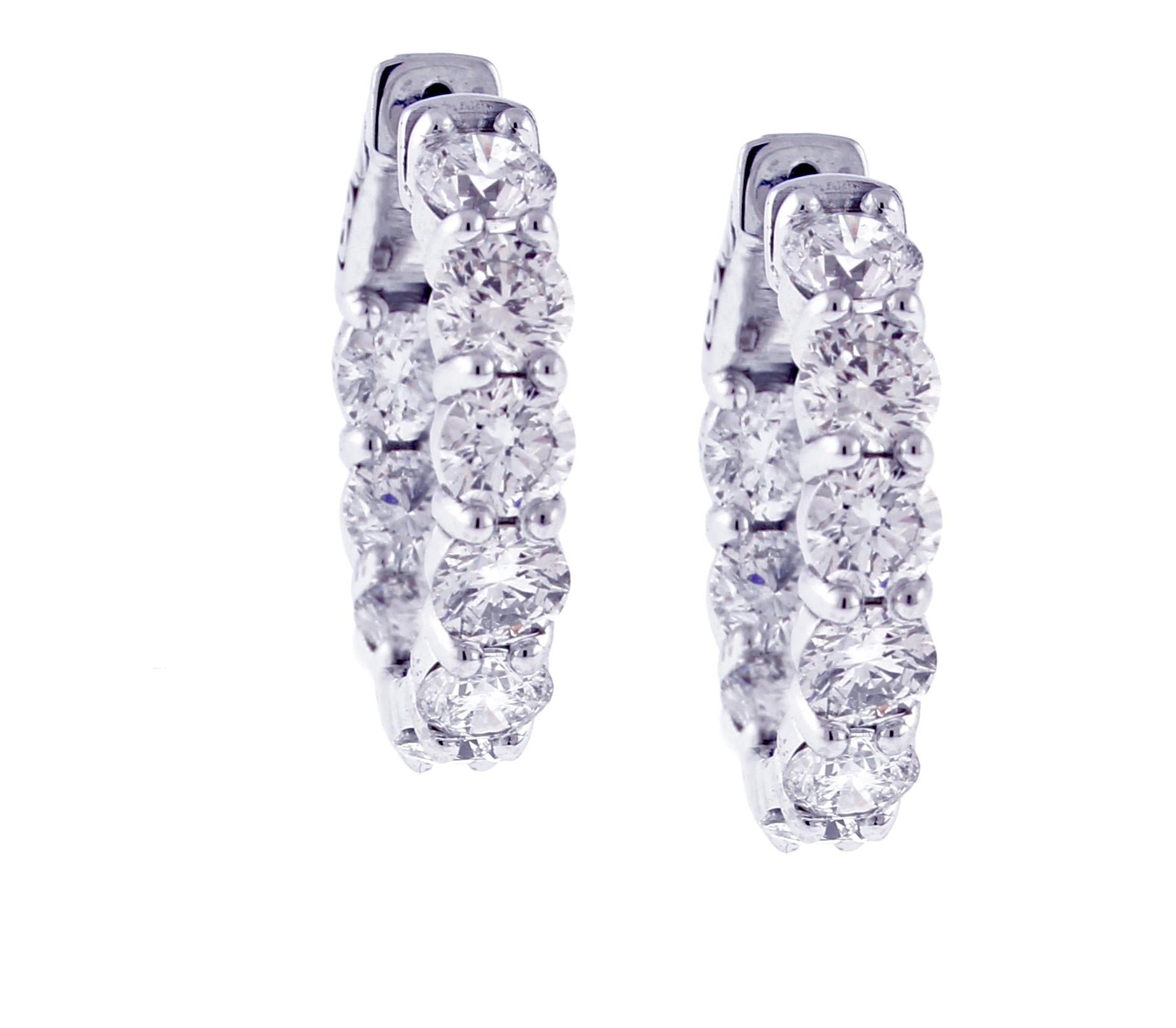 A pair of diamond hoop earring. The  ¾ of an inch diameter round hoop earring have diamonds set on the outside and inside.  
♦ Designer: Pampillonia
♦ Metal: 14 karat
♦ 18 diamonds=4.80 carats,  I-J VS
♦ Circa 2022
♦  about ¾ in diameter, 1/8 of an