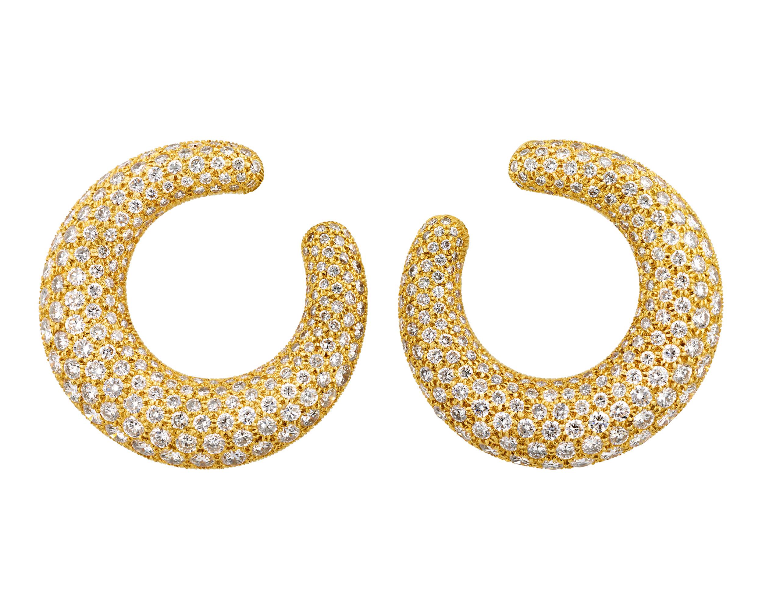 These bold and sophisticated earrings by Cartier feature a unique elongated hoop design. The glamorous earrings include approximately 12.00 carats of dazzling white diamonds, artfully arranged in 18K yellow gold hoops.

Cartier, the renowned French