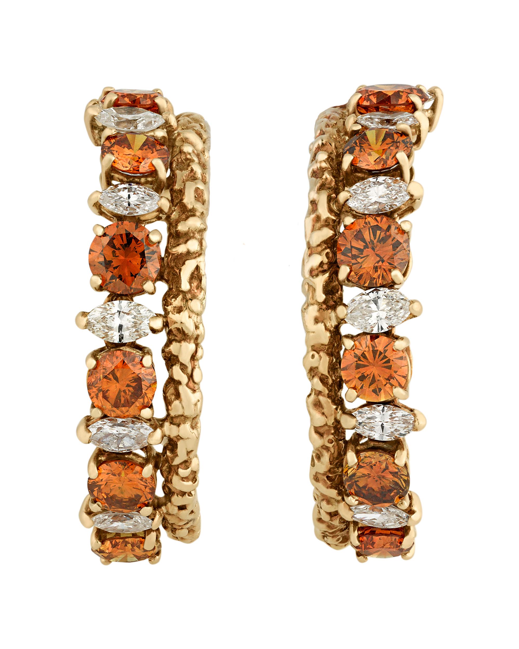 Stunning white and colored diamonds adorn these hoop earrings by the esteemed Van Cleef & Arpels. Twelve round natural brownish-orange diamonds totaling 1.00 carat are punctuated by twelve marquise-cut white diamonds totaling approximately 1.00
