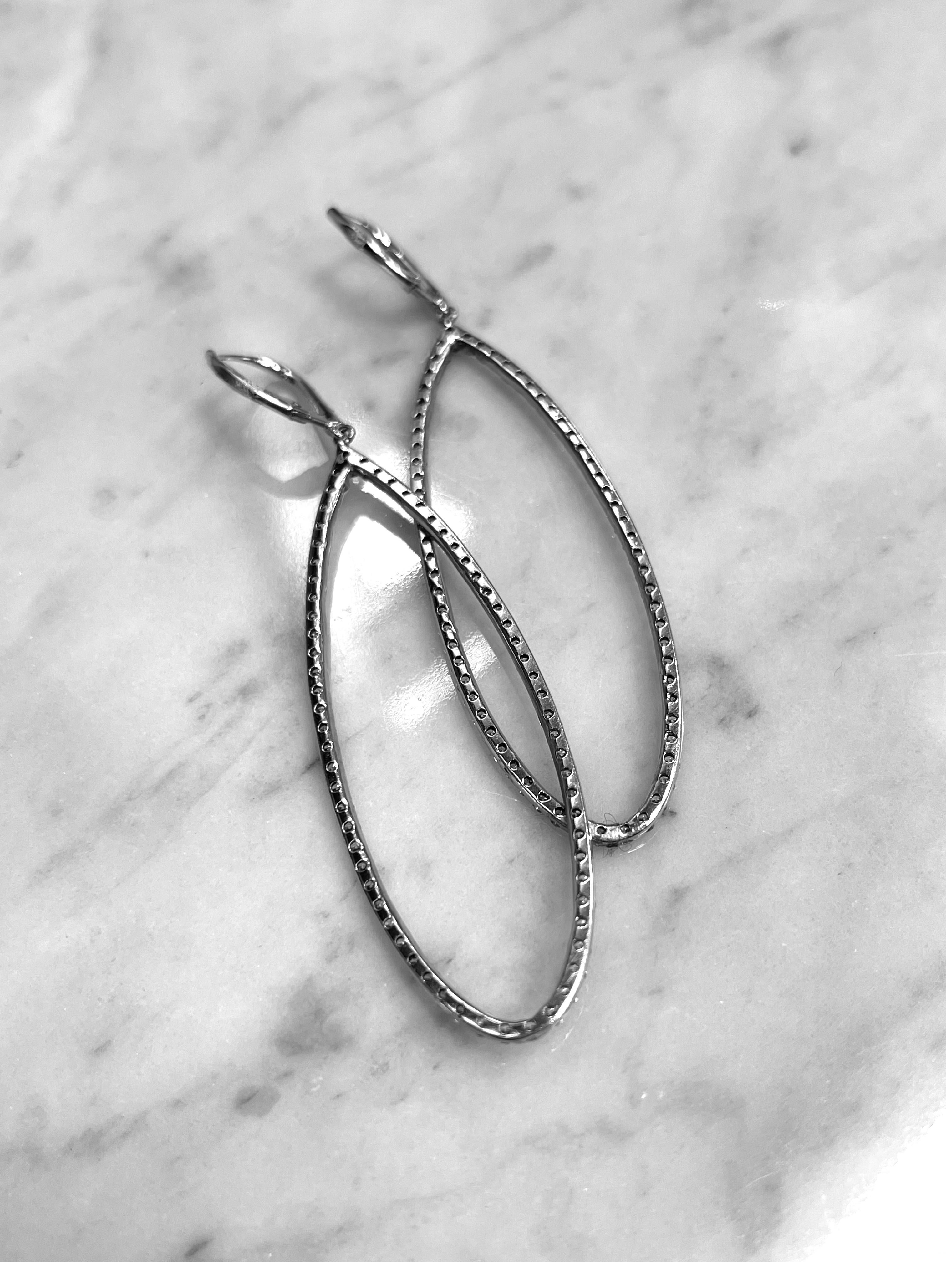 These beautiful Oval Diamond Hoop Earrings have a total of 150 Round Brilliant Cut Diamonds weighing 2.46ctw F-VS in Quality and Set in 14K White Gold. 