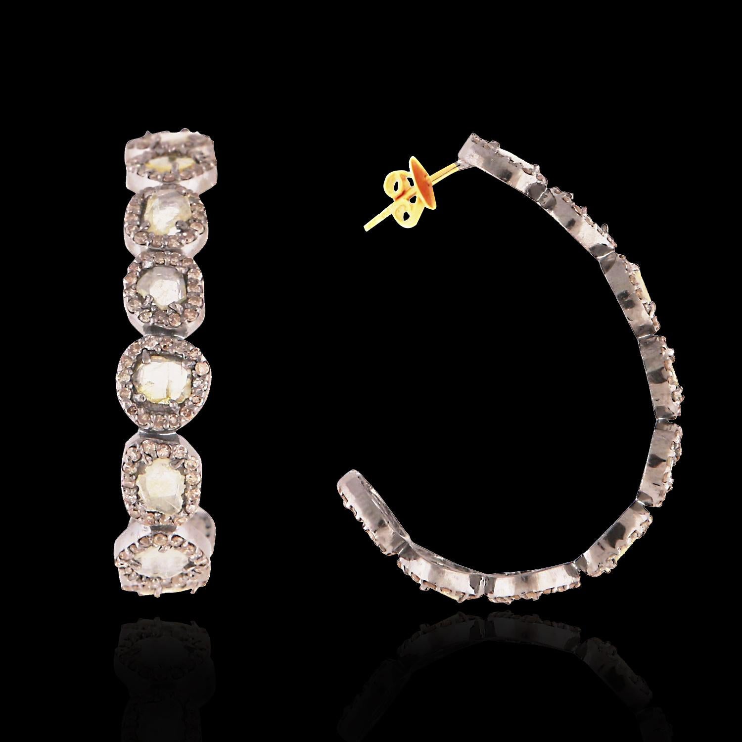 A pretty pair of diamond hoop earrings set with uncut sliced diamonds (1.15 carat), and single cut diamonds (1.27 carat).  0.9 grams 14kt gold and 5 grams silver.

Very light weight for pierced ears. 

2.5 cm in full length.