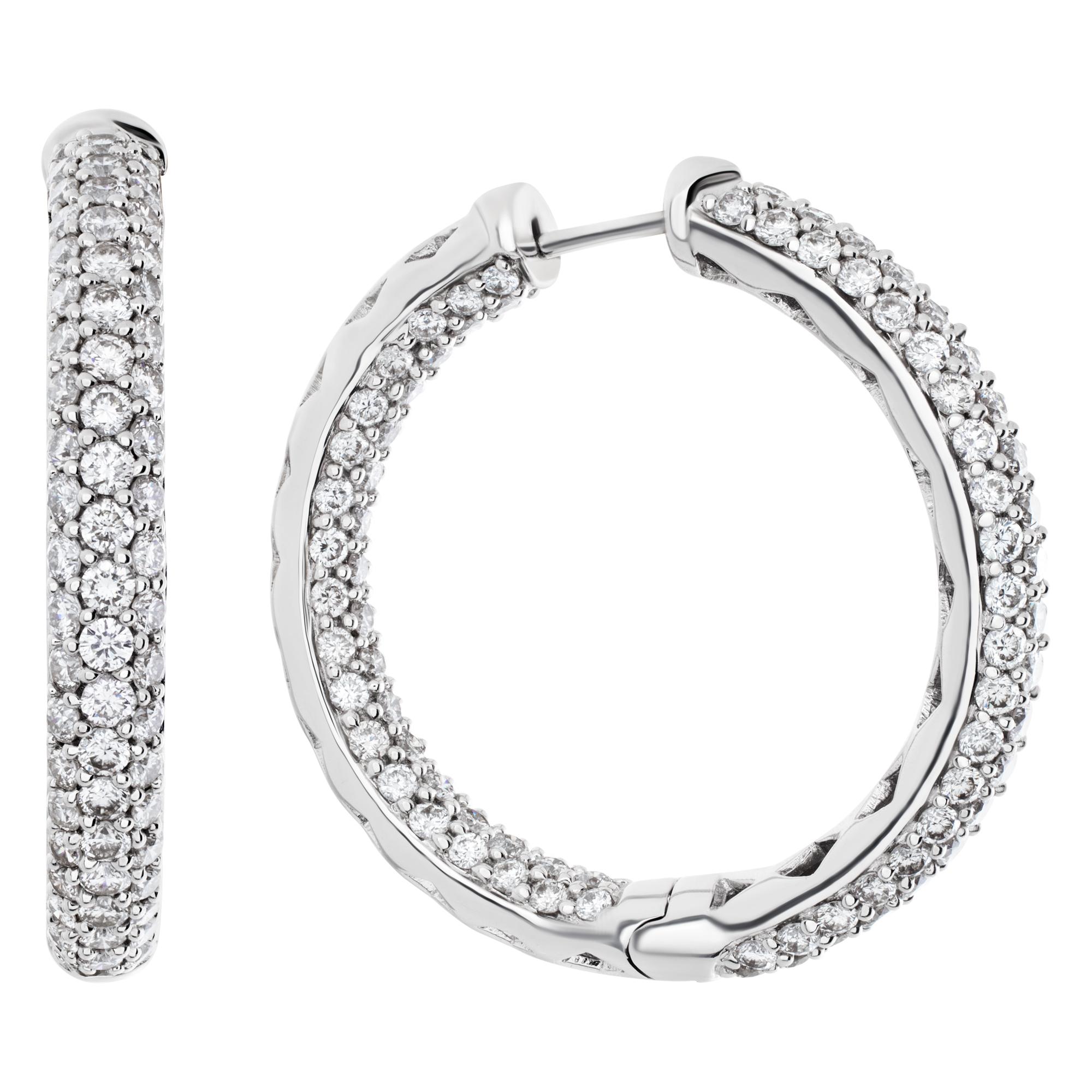 Diamond hoop earrings in 18k white gold with approximately 3.50 carats of estimated G-H color and SI1 clarity diamonds. 32 mm diameter with secure post closure.