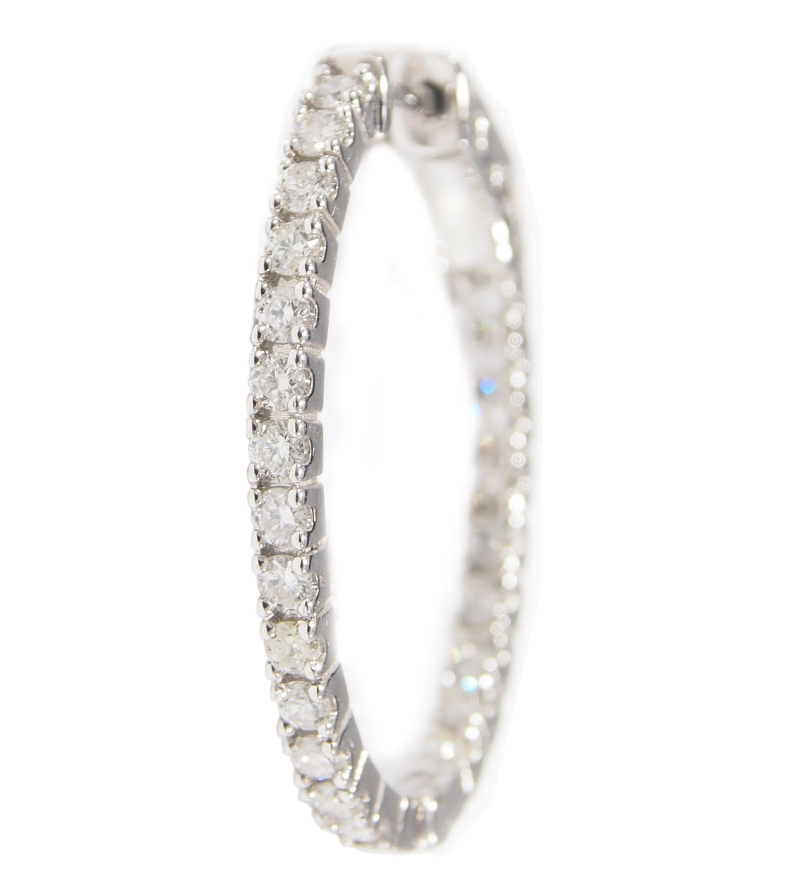 These are a classic pair of 14K White Gold Hoop Earrings fashioned in an Oval with the Diamonds in the desired 